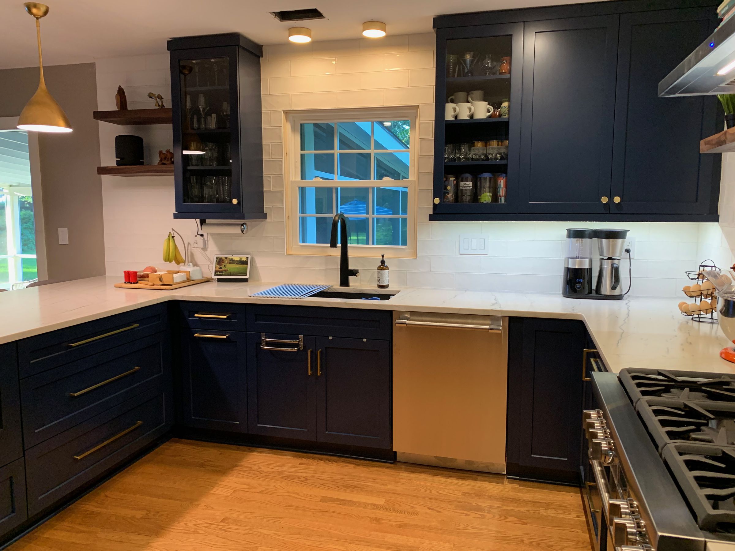 A kitchen with a window, a sink, and a dishwasher.