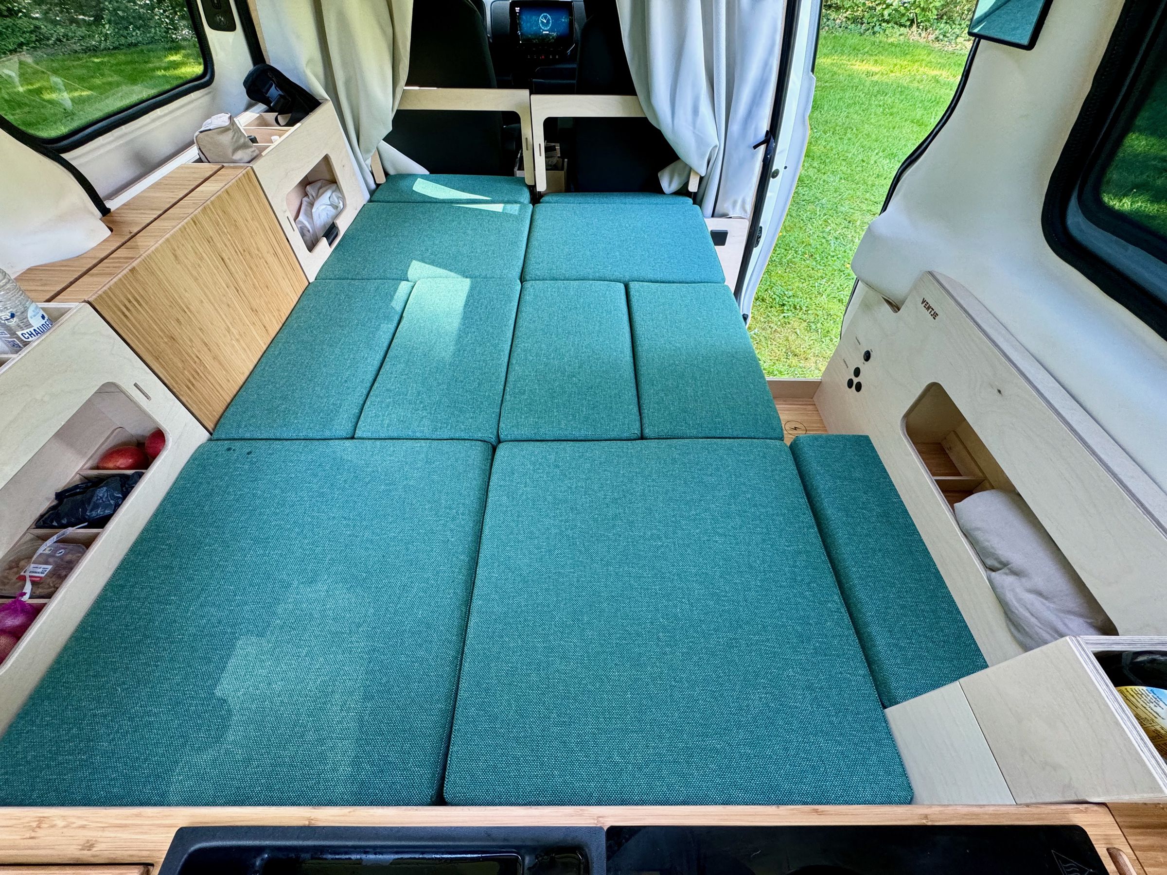 <em>The lower bed gets longer when you move the front seats forward to flip up two extension panels (only the left is shown in this photo).</em>