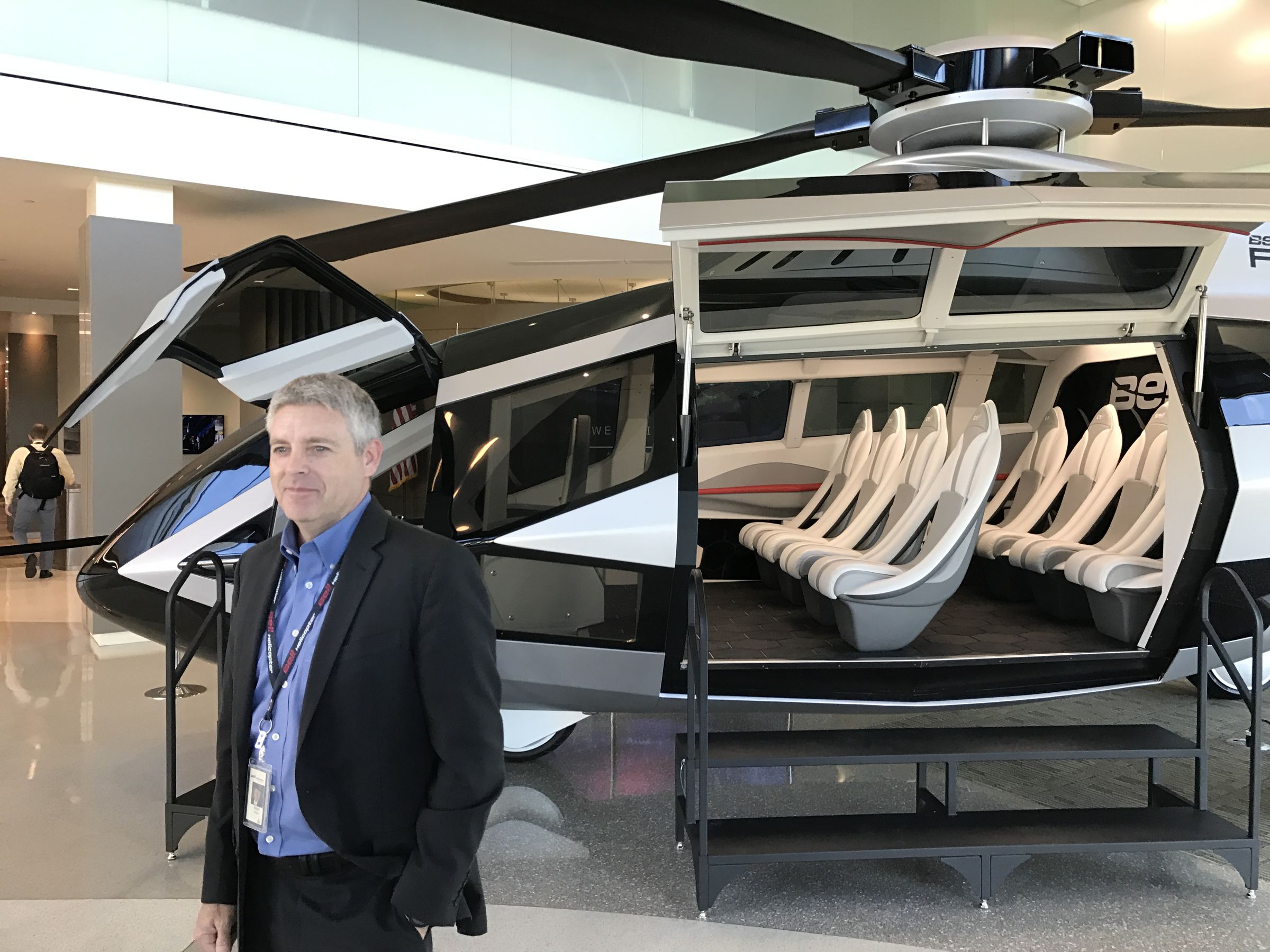 Bell Helicopter CEO Mitch Snyder, standing next to the futuristic concept FCX-001.
