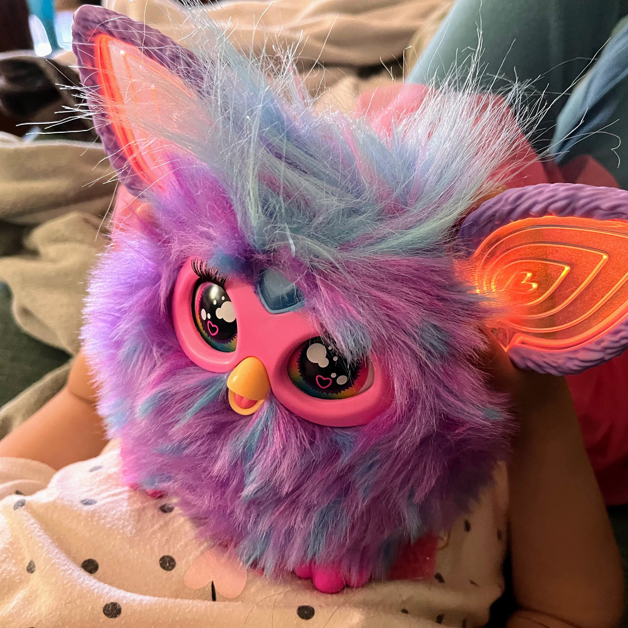 a purple fuzzball of a toy with moving eyes and ears lit by RGB LEDs and a heart button on its forehead