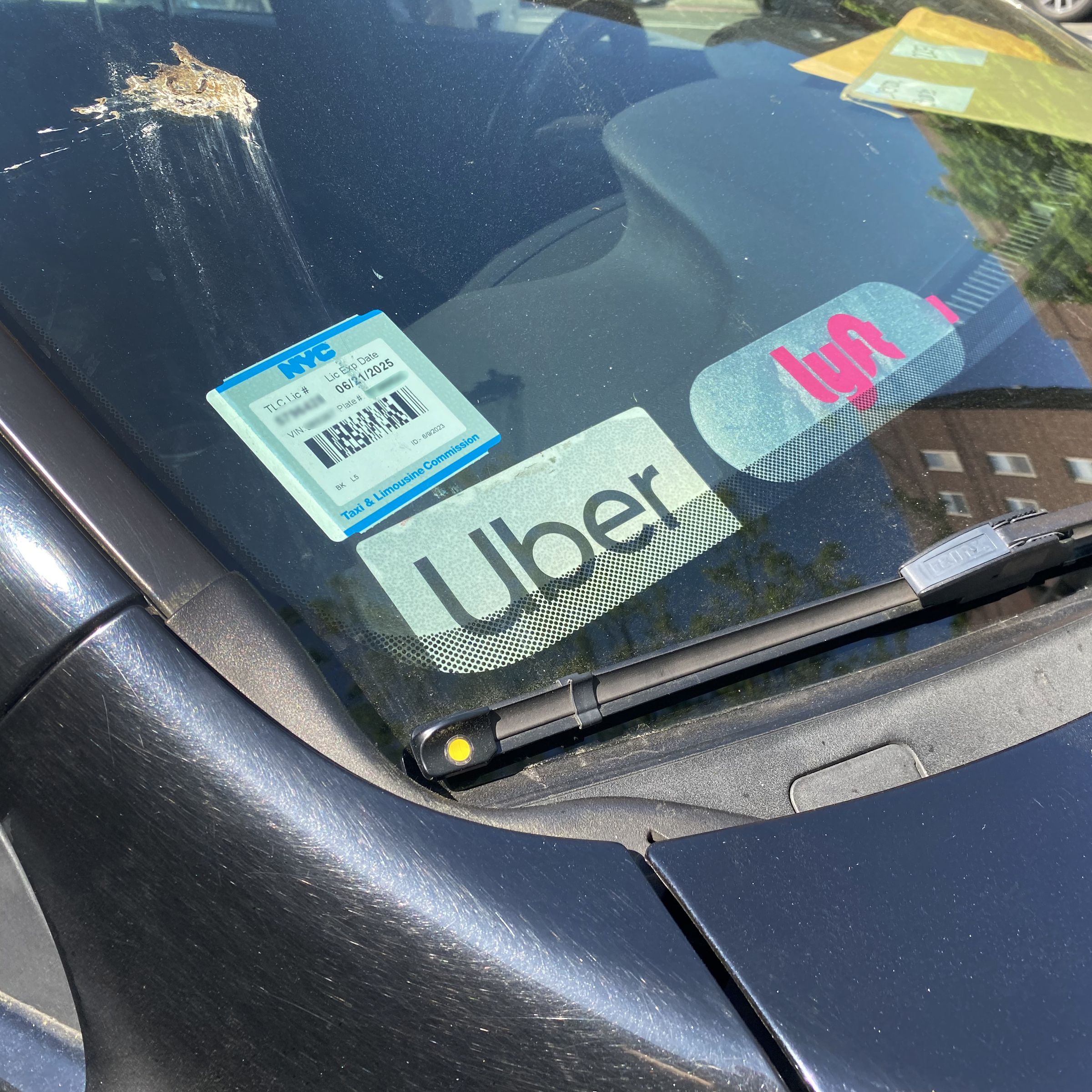 Uber and Lyft Driver, signs in car window, Queens, New York