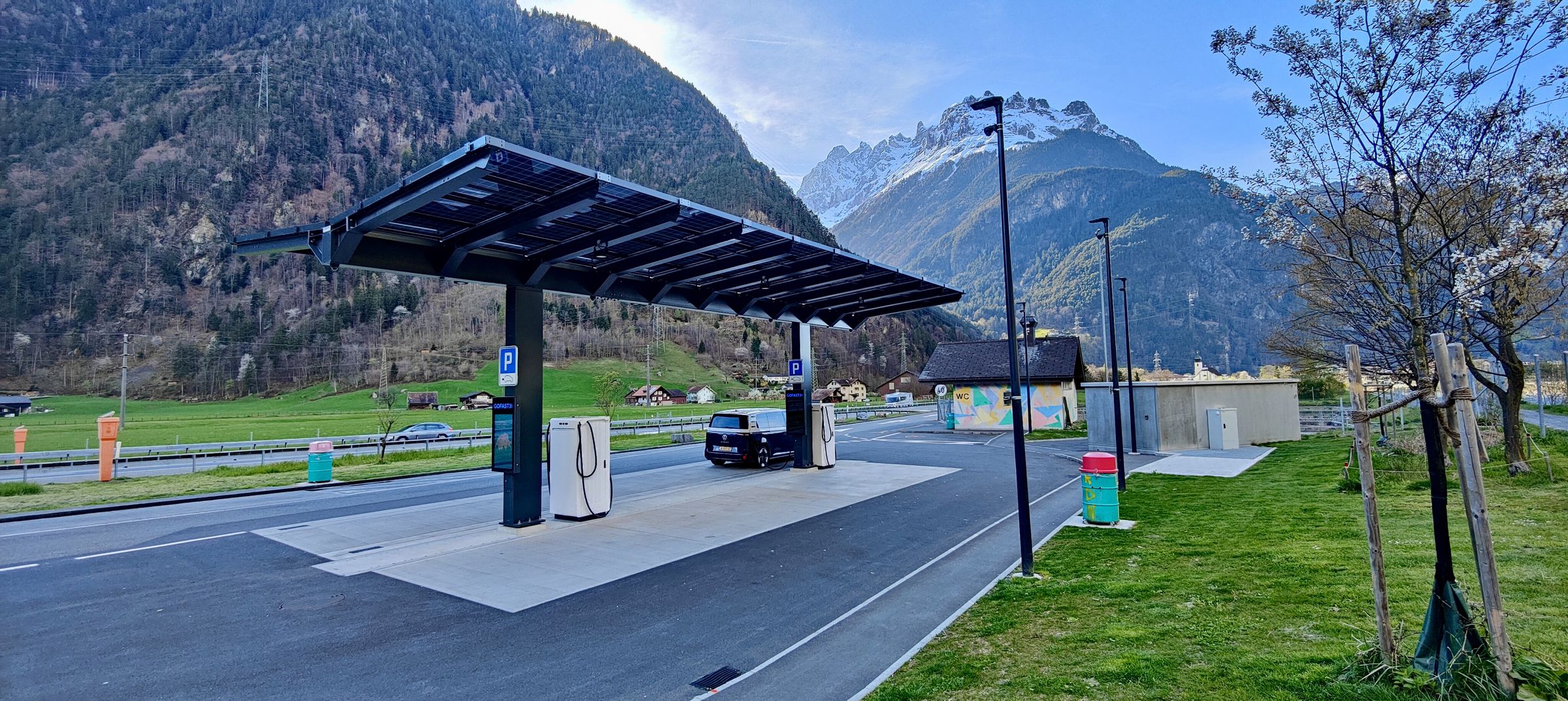 <em>A typical scene at ultra-fast charging stations: everything working and lots of availability. This one had a long protected walking path for the dog along the right-hand side bordering a creek. </em>