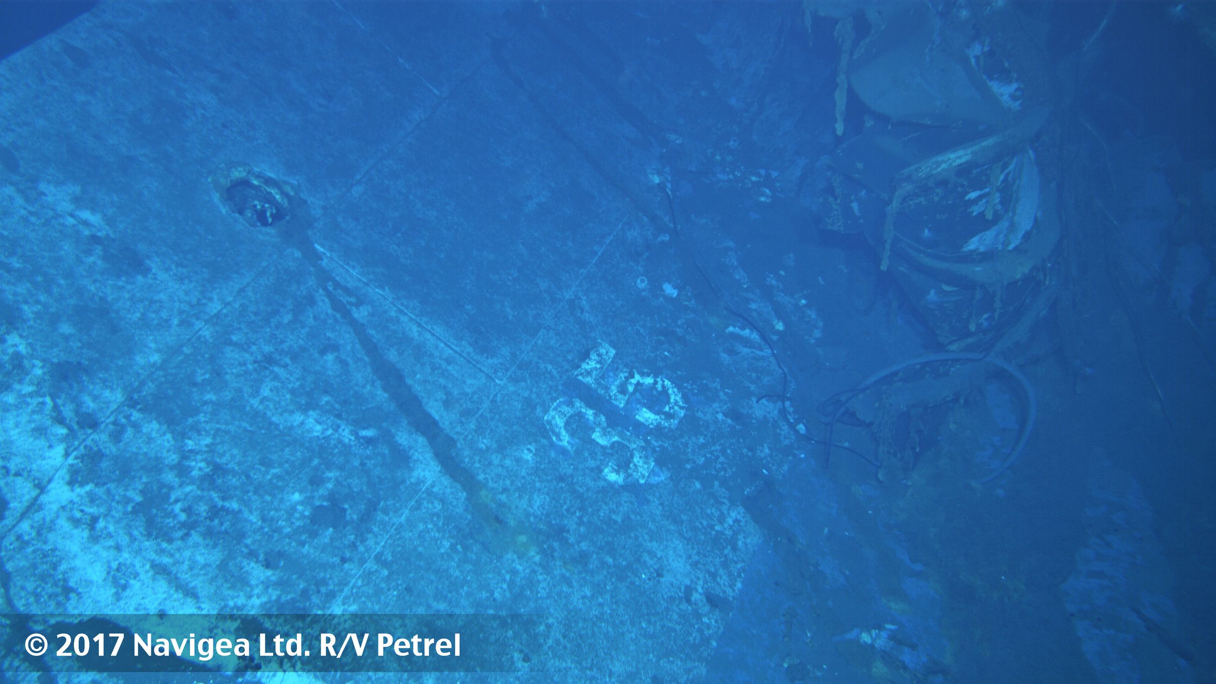 An image shot from a remotely operated vehicle shows what appears to be the painted hull number "35." Based on the curvature of the hull section, this seems to be the port side of the ship.  Using this photo as a reference, the number is painted in the same font, and the "3" aligns with the circular feature above it in both photos. 