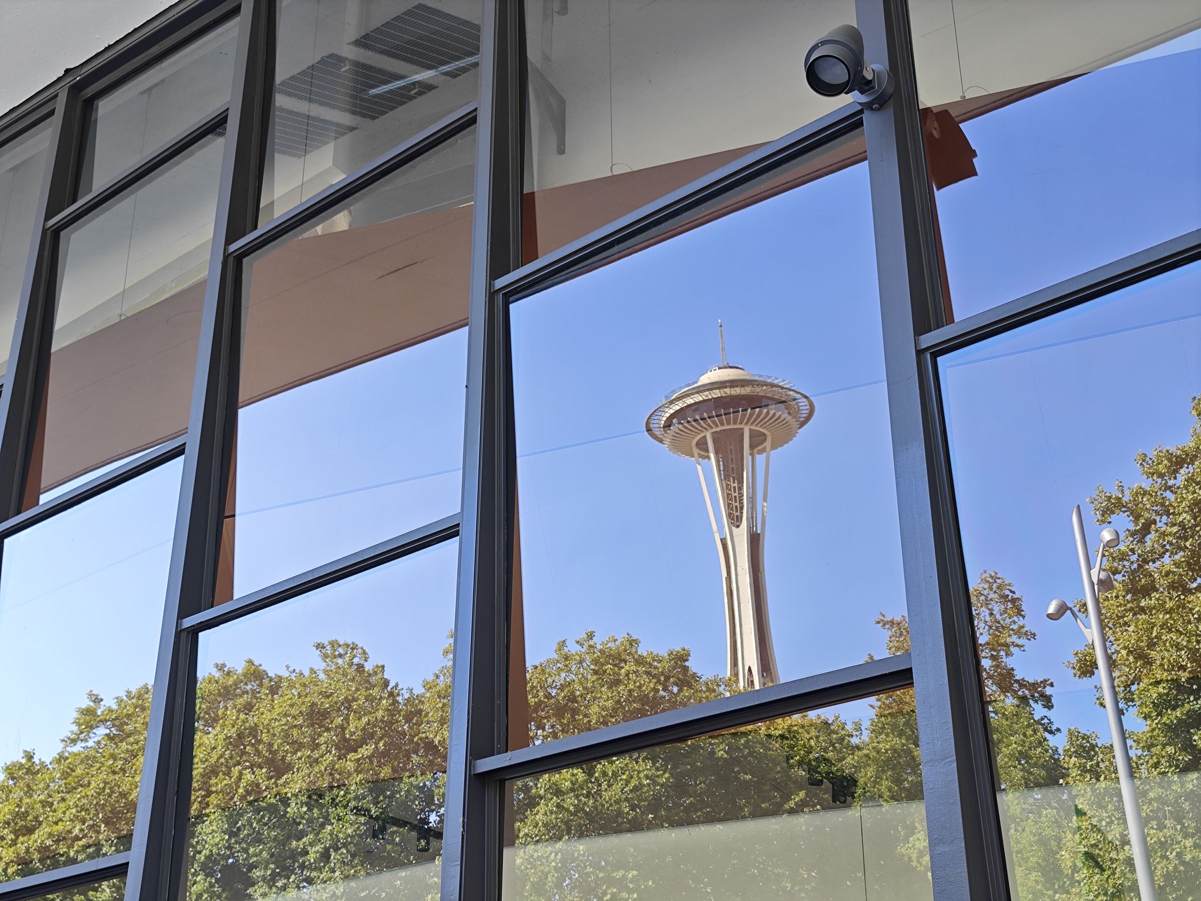 Photo of reflection of the Space Needle in a window.