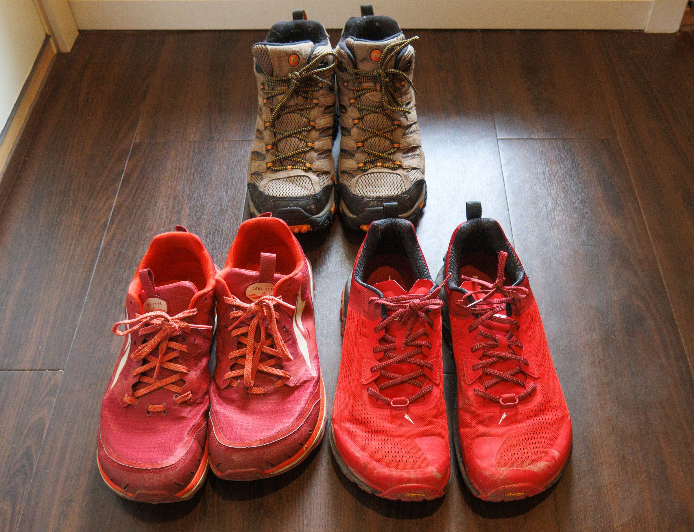 Photos of two pairs of running shoes in front of a pair of boots.