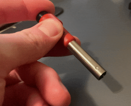 GIF of a person pushing a button and it creating a spark.