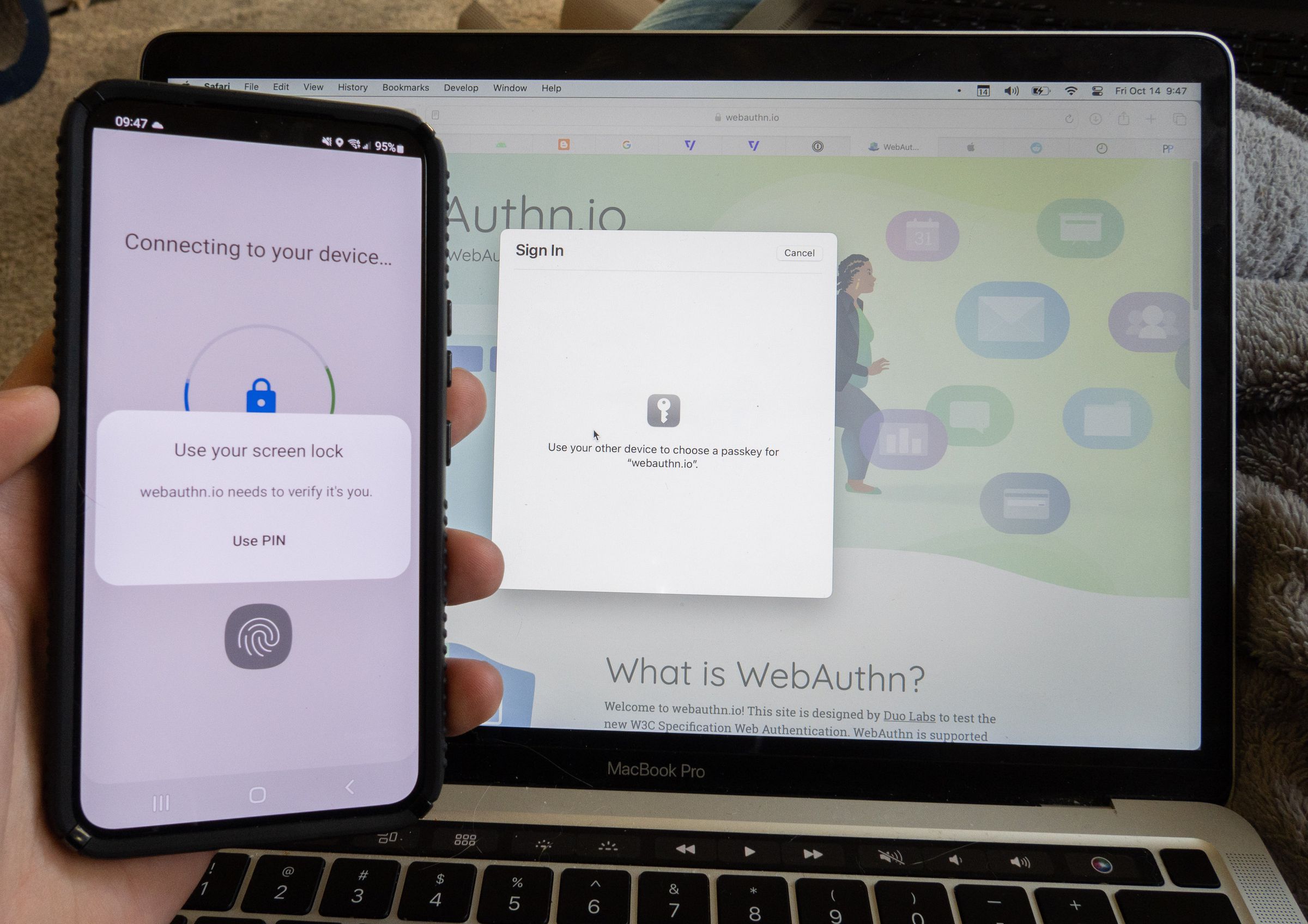 Photo of an Android phone that says “connecting to your device, use your screen lock,” in front of a MacBook that says “use your device to choose a passkey.”