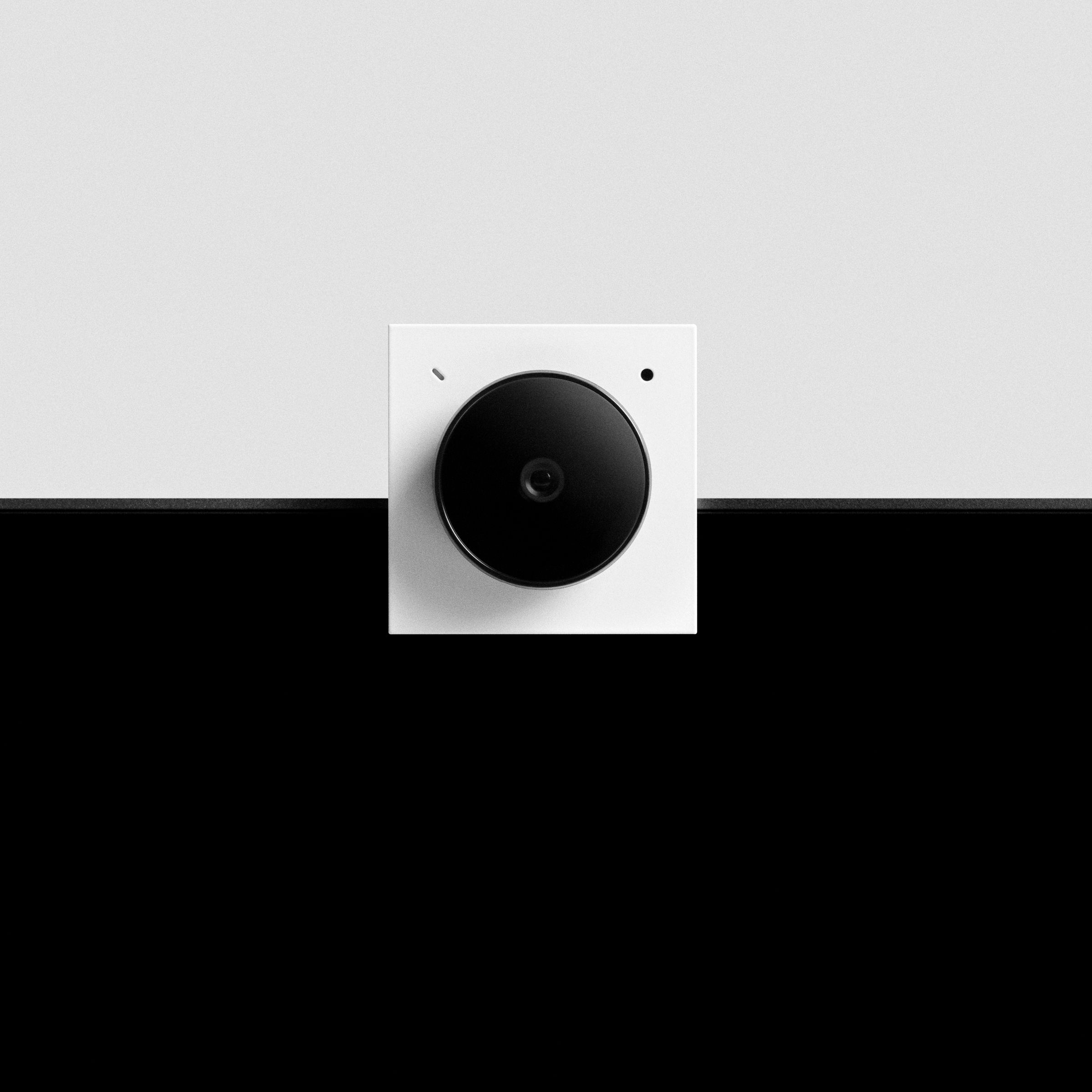 An image of a small camera attached to a laptop screen.