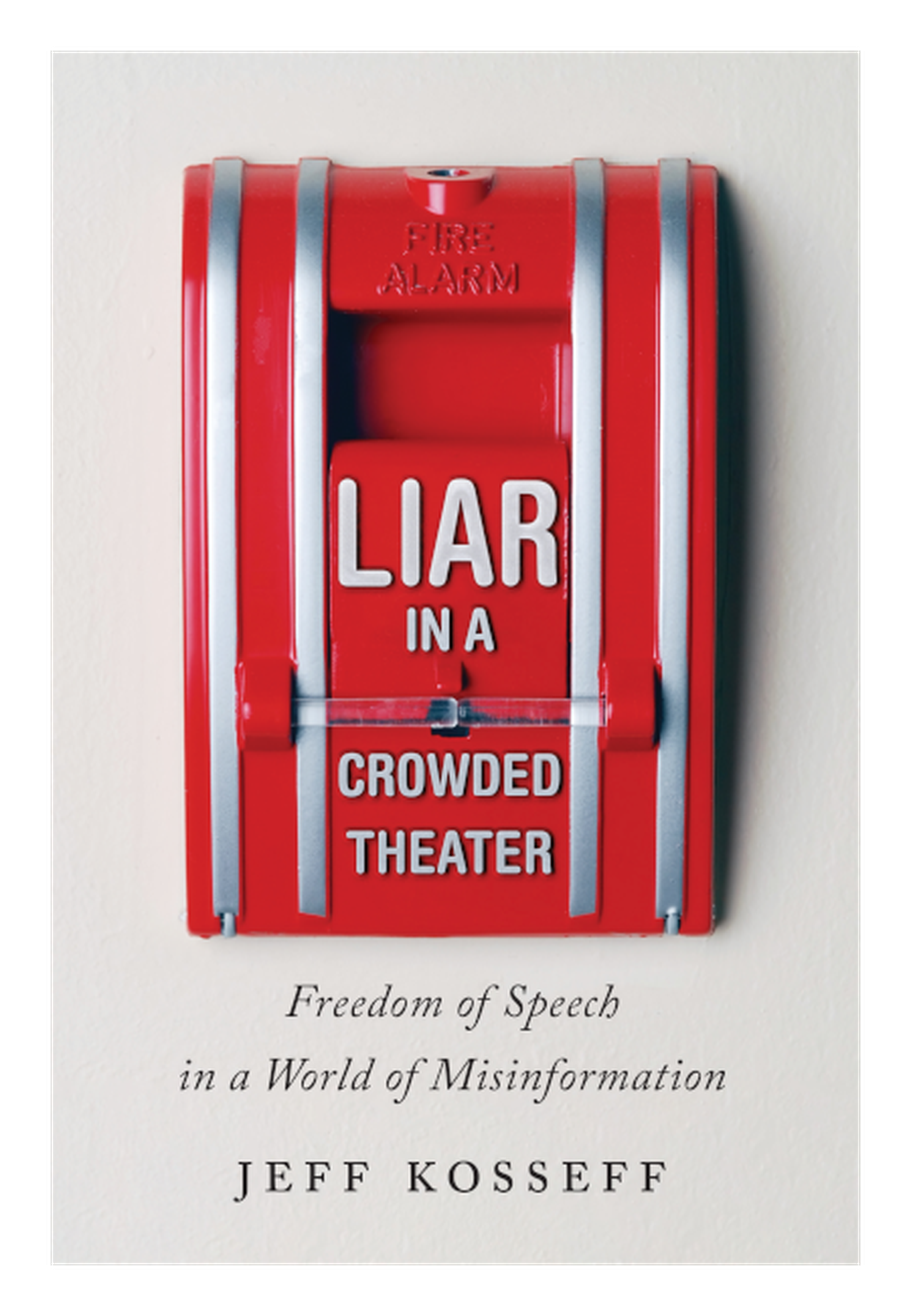 The book cover, featuring the title “Liar in a Crowded Theater” on an image of a fire alarm