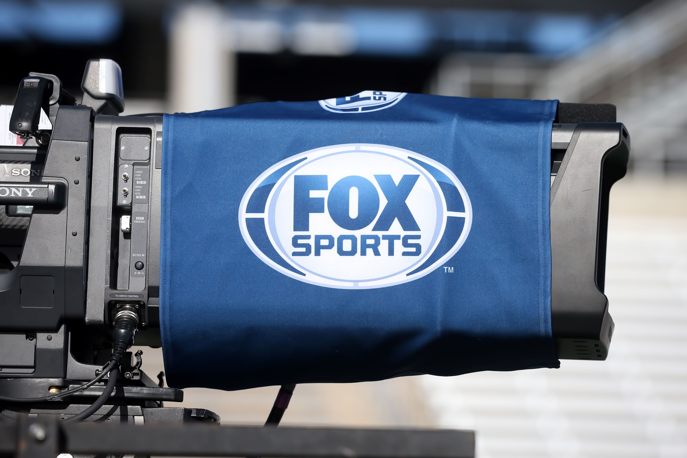 And image of the Fox Sports logo on a broadcast camera lens.