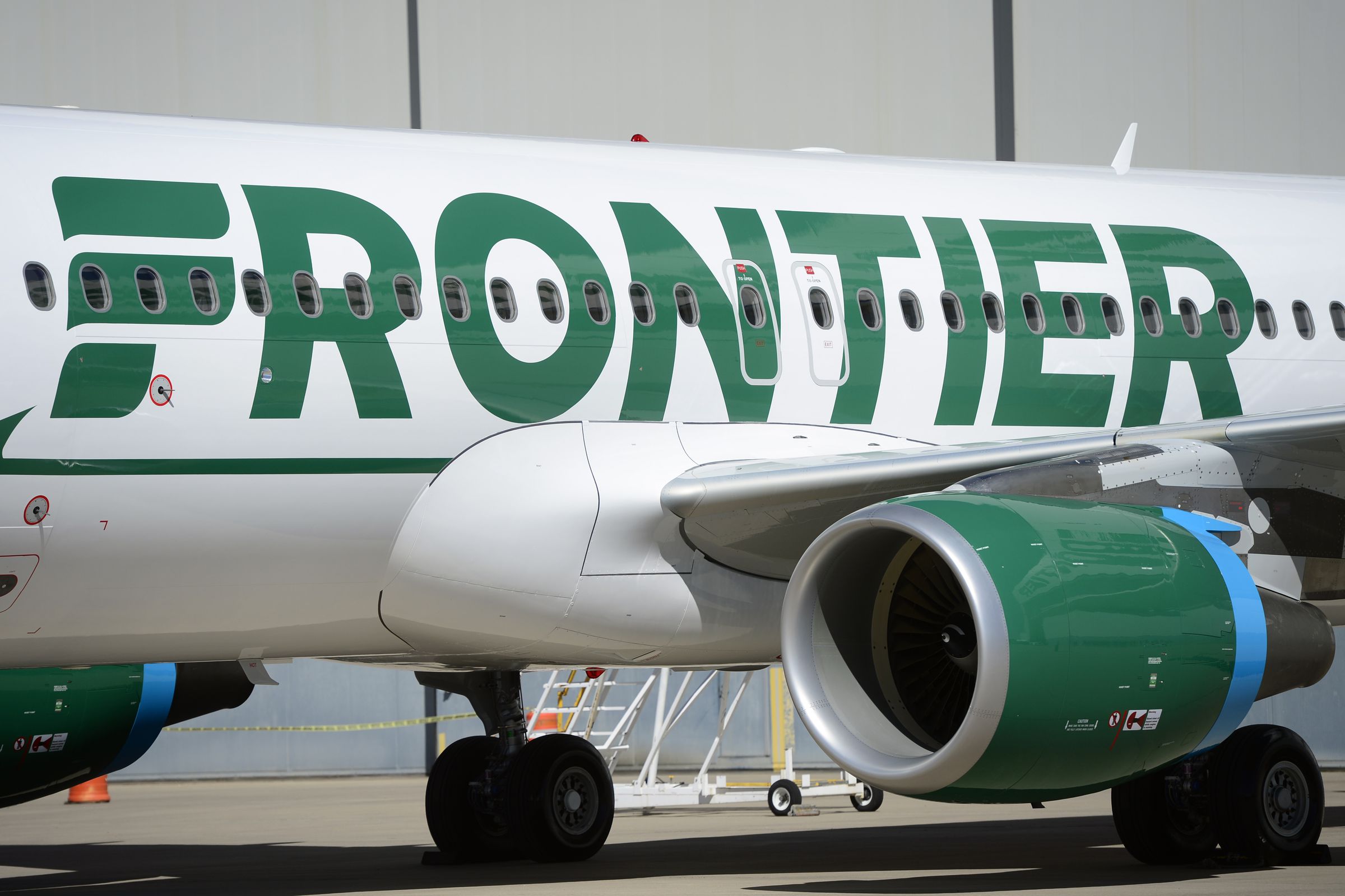 Frontier employees and executives physically pull a 46-ton Airbus A320 out of the Frontier Airlines hanger at Denver International Airport in Denver.