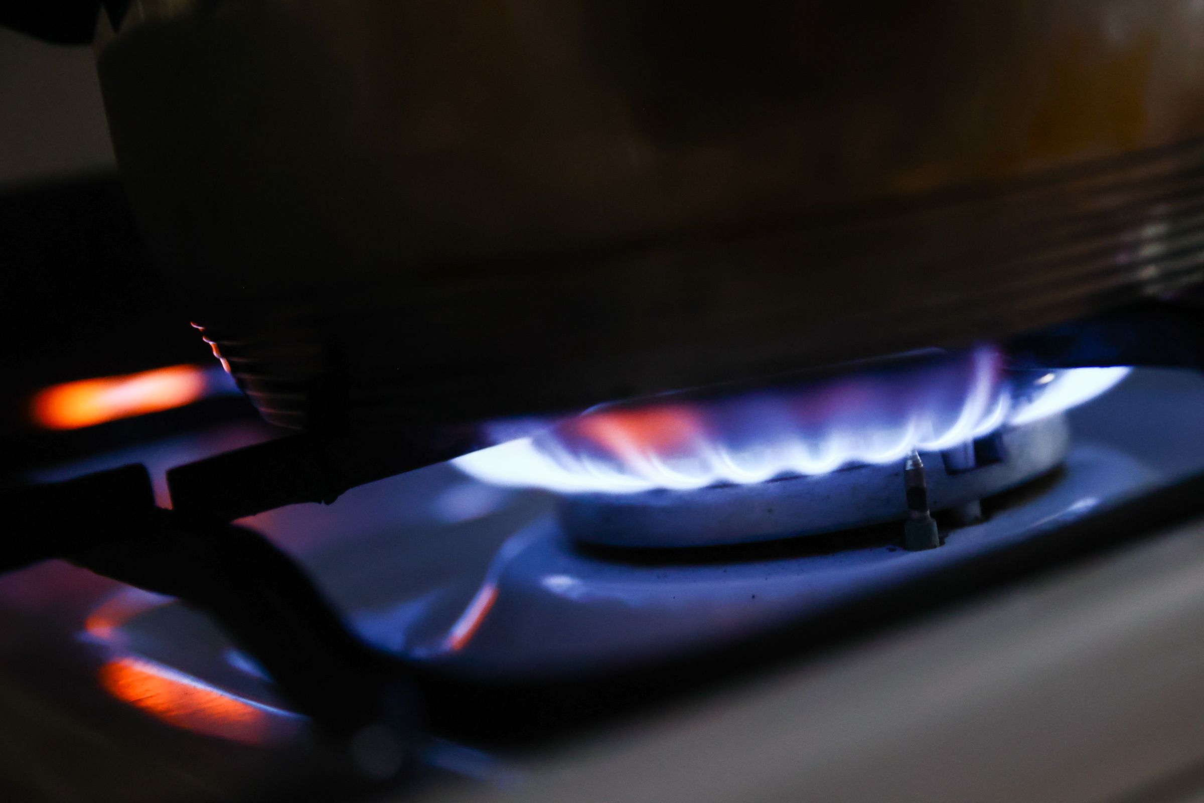 A lot gas burner with blue and orange flames.