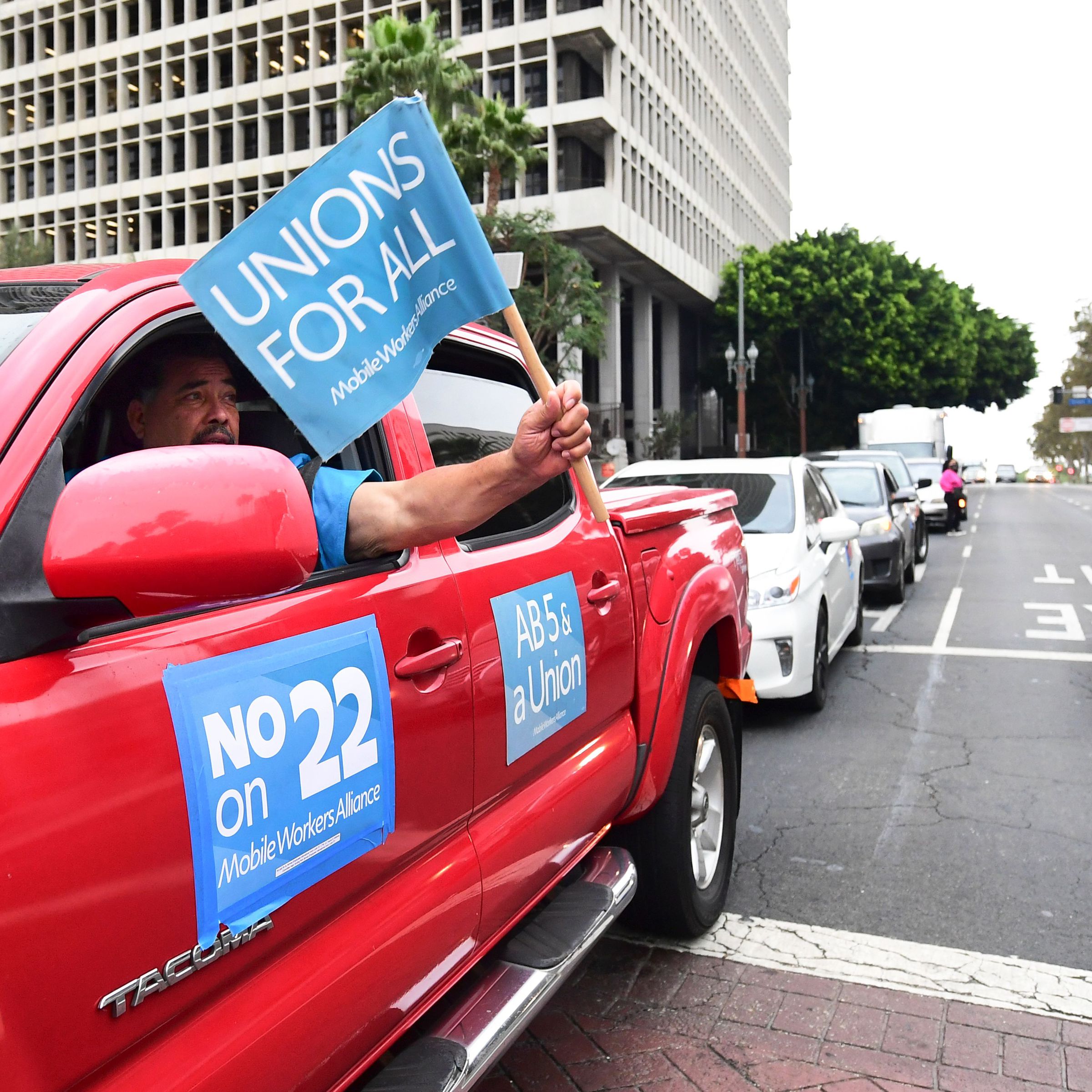 Uber and Lyft drivers protest Proposition 22 outside Los Angeles City Hall on October 22, 2020.