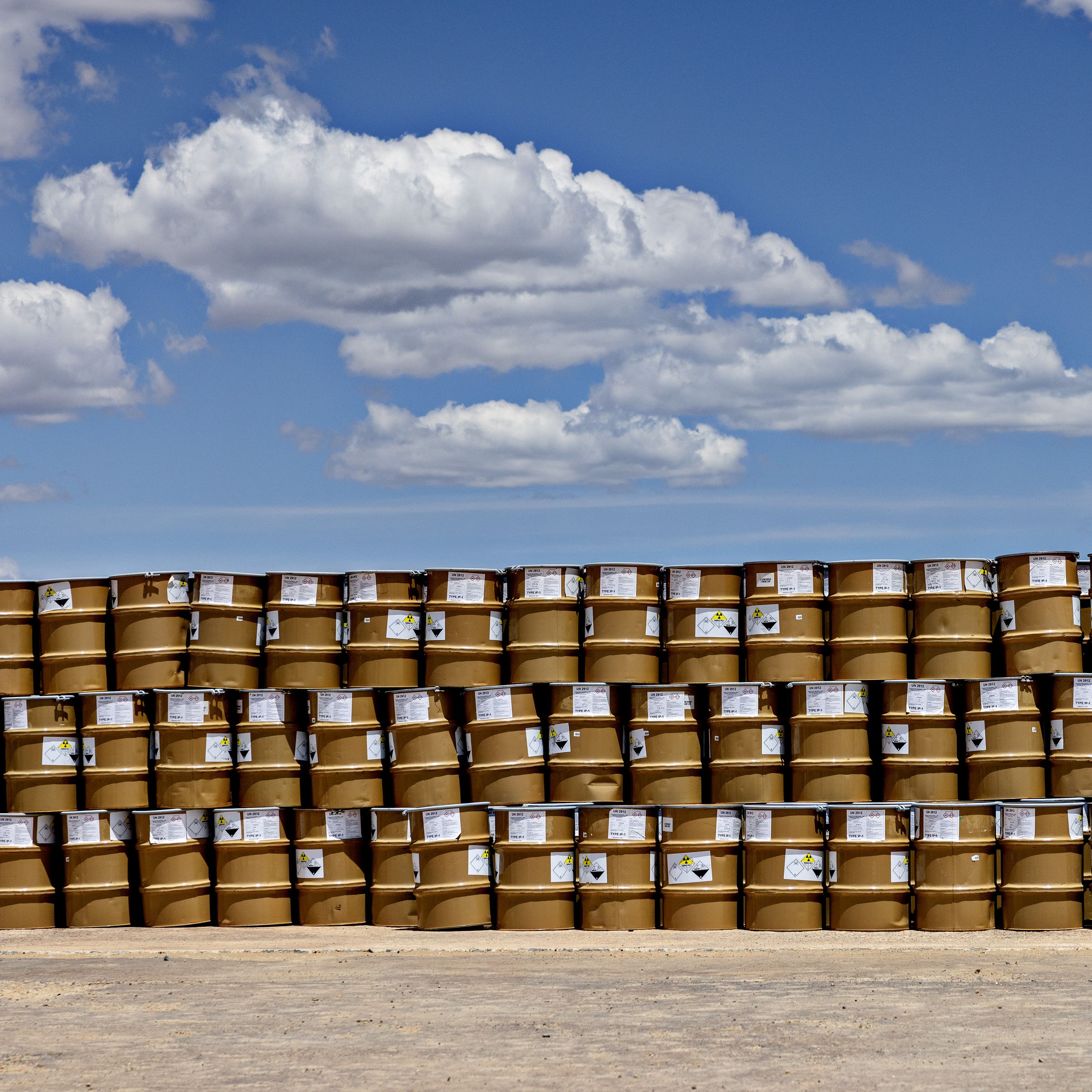A long stack of barrels three rows high.