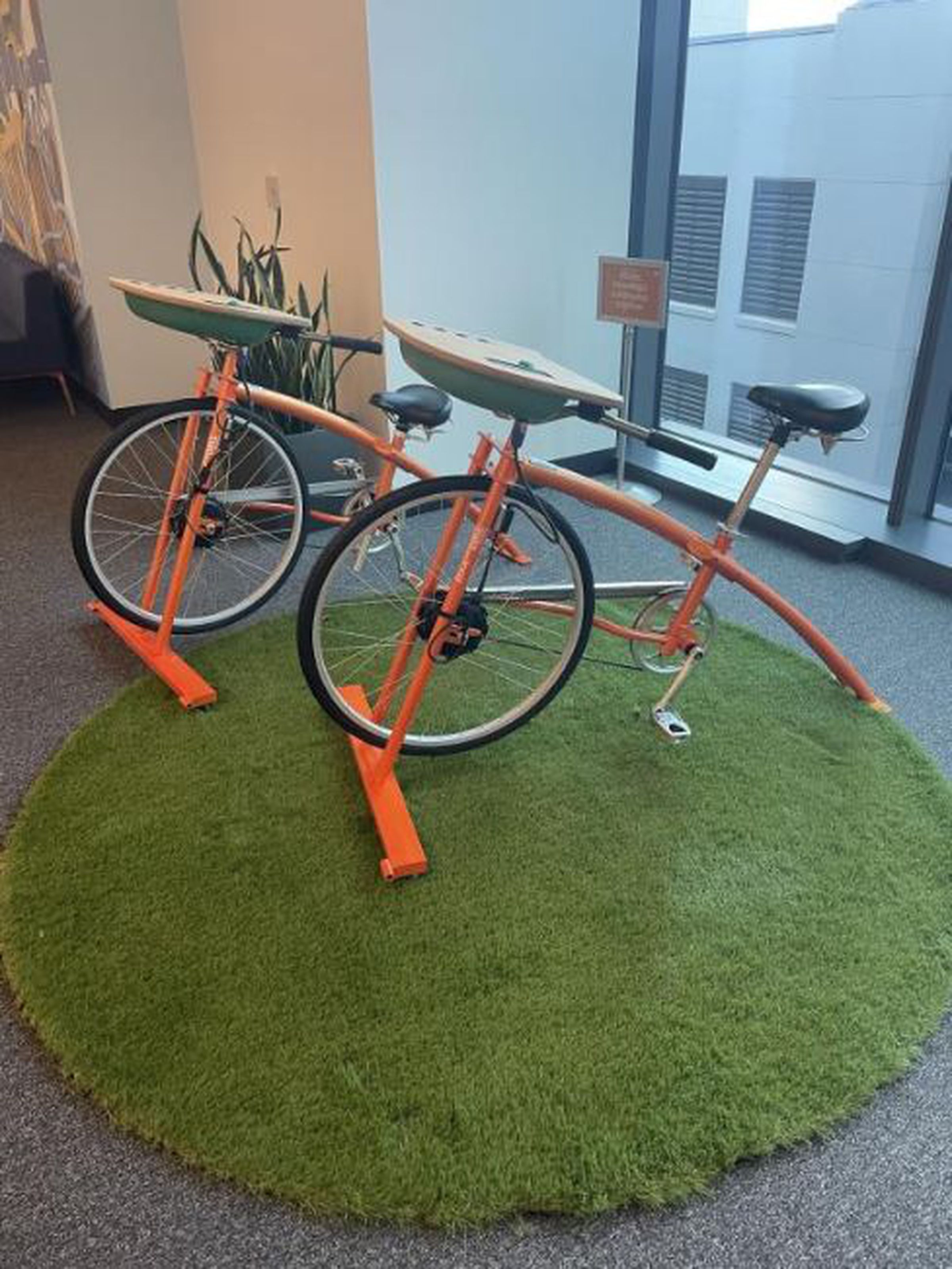 Two Rock the Bike recharging stations on a green rug
