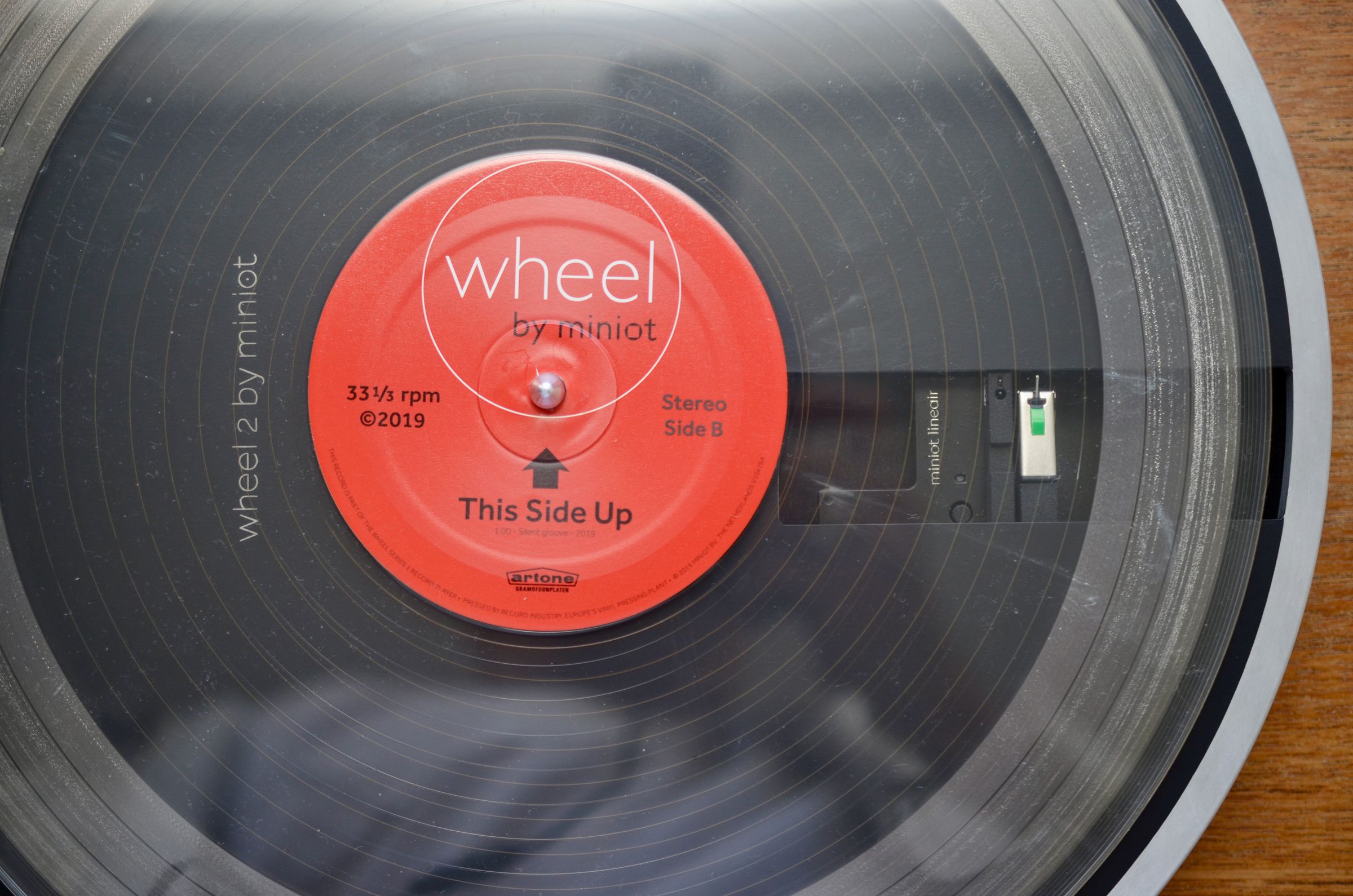 Here, you can see the tonearm beneath the transparent record supplied with every Wheel 2 turntable.