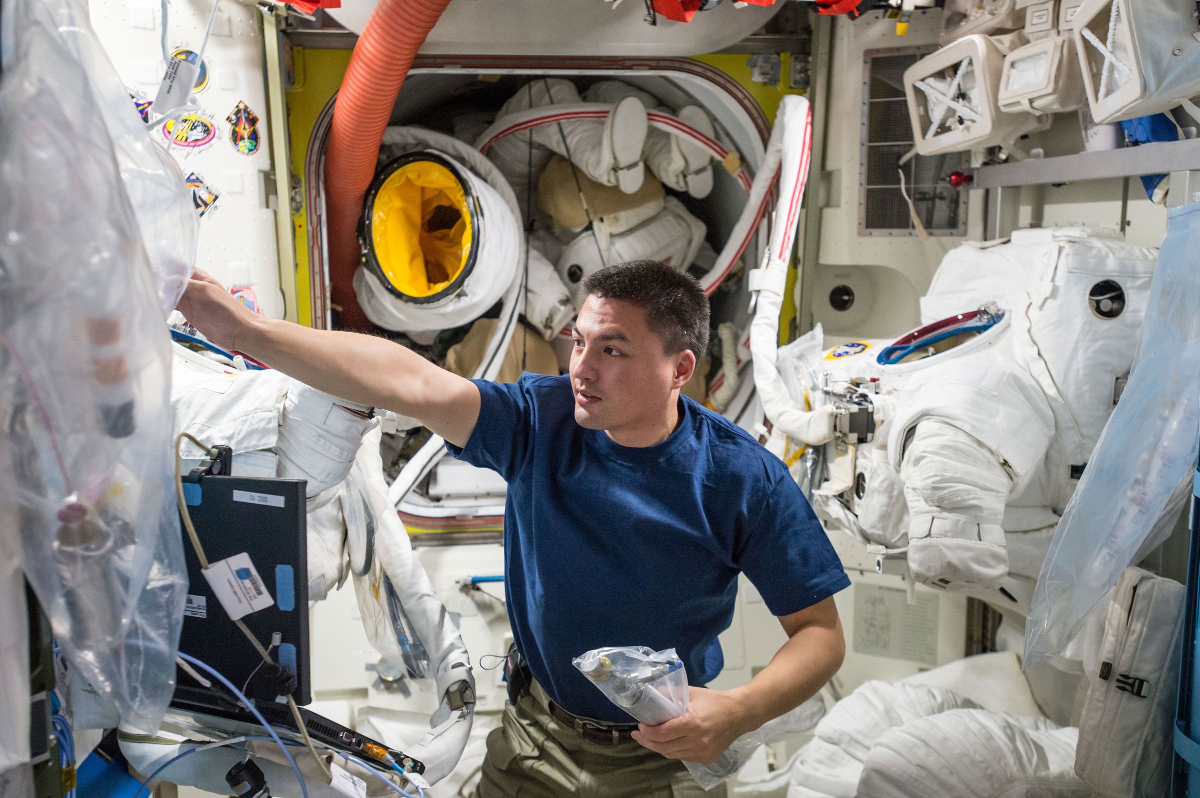 NASA astronaut Kjell Lindgren doing maintenance on the ISS space suits.