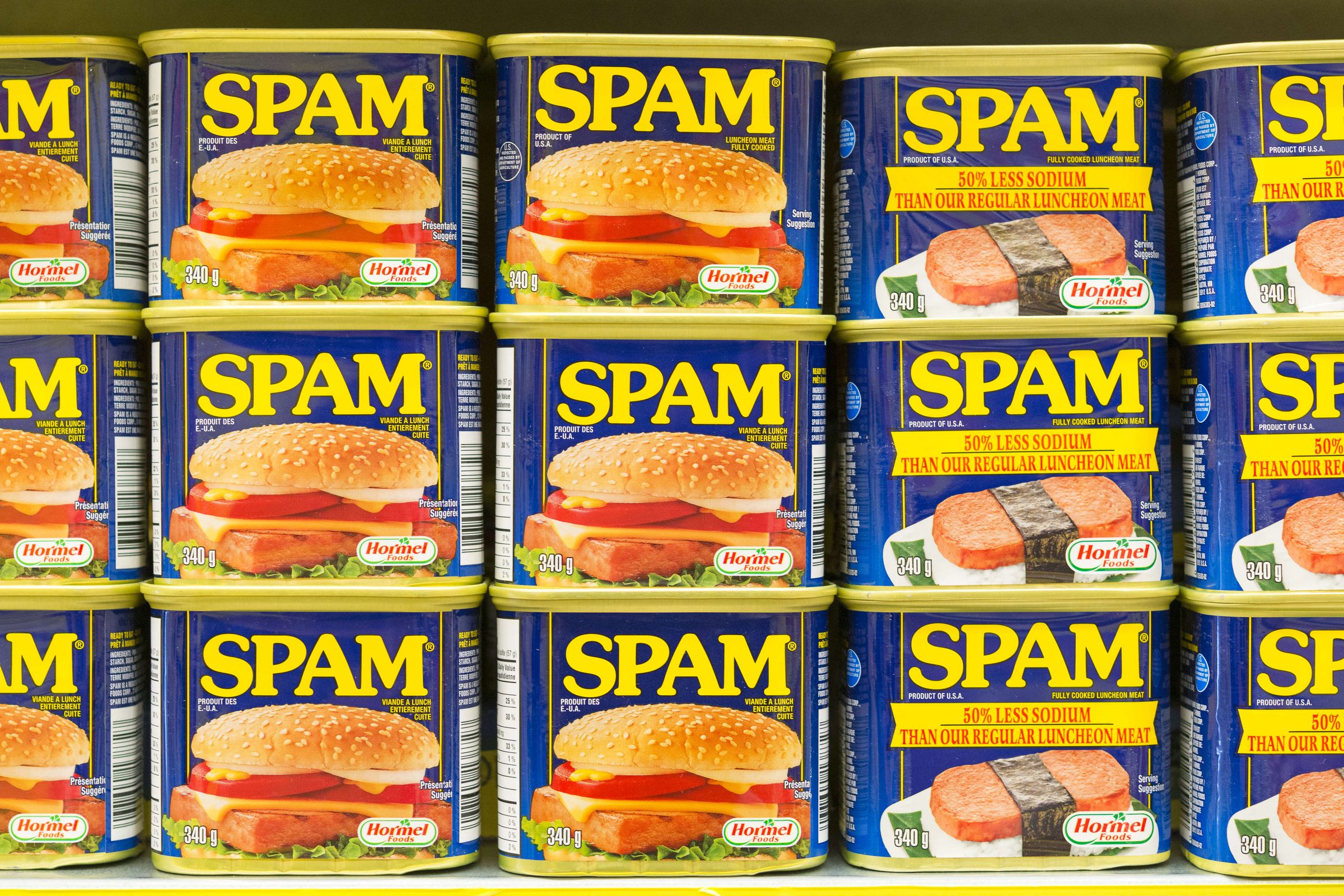 Spam canned meat stacked vertically in store shelf. Spam is...