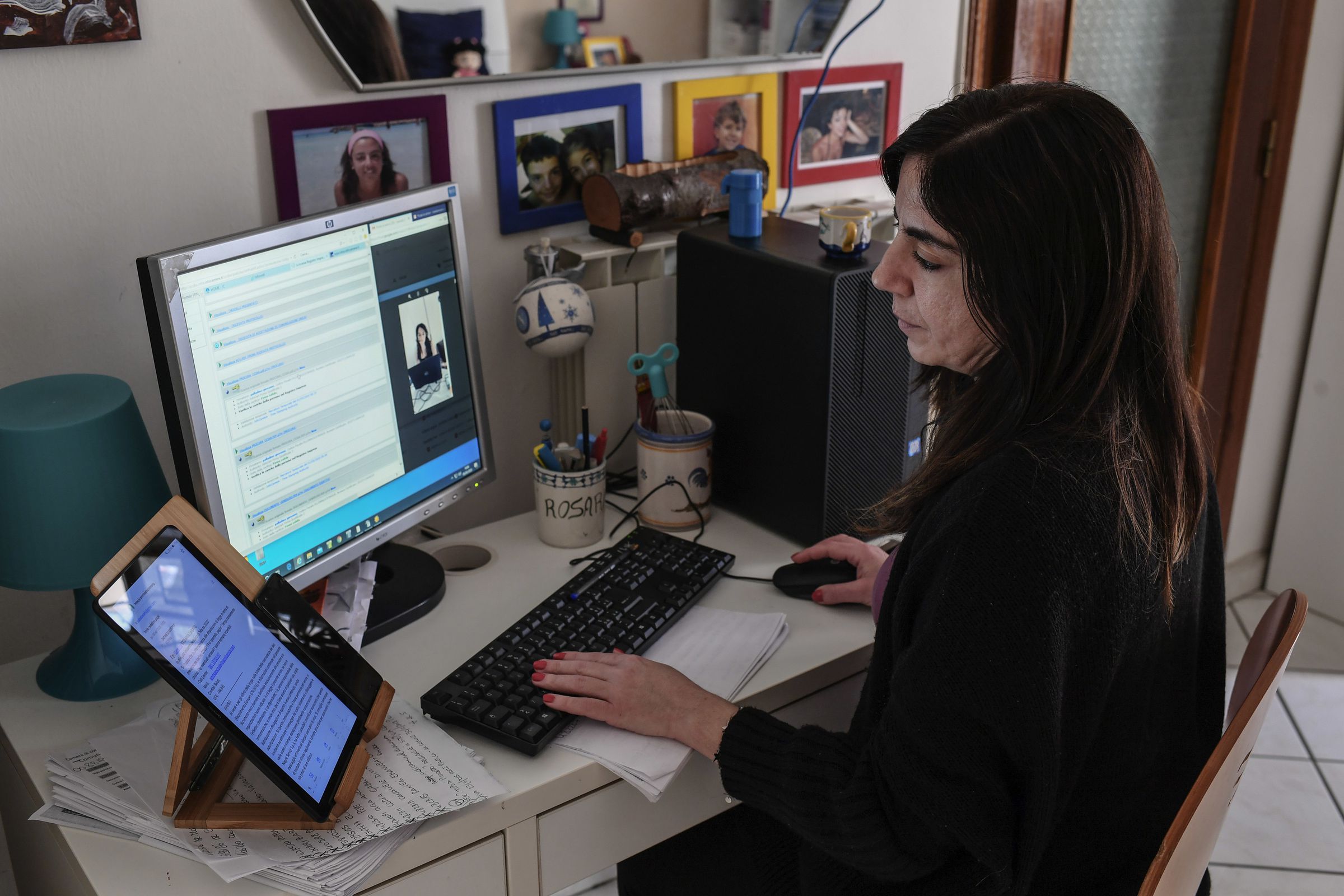A woman works from her home in streaming contact with a...