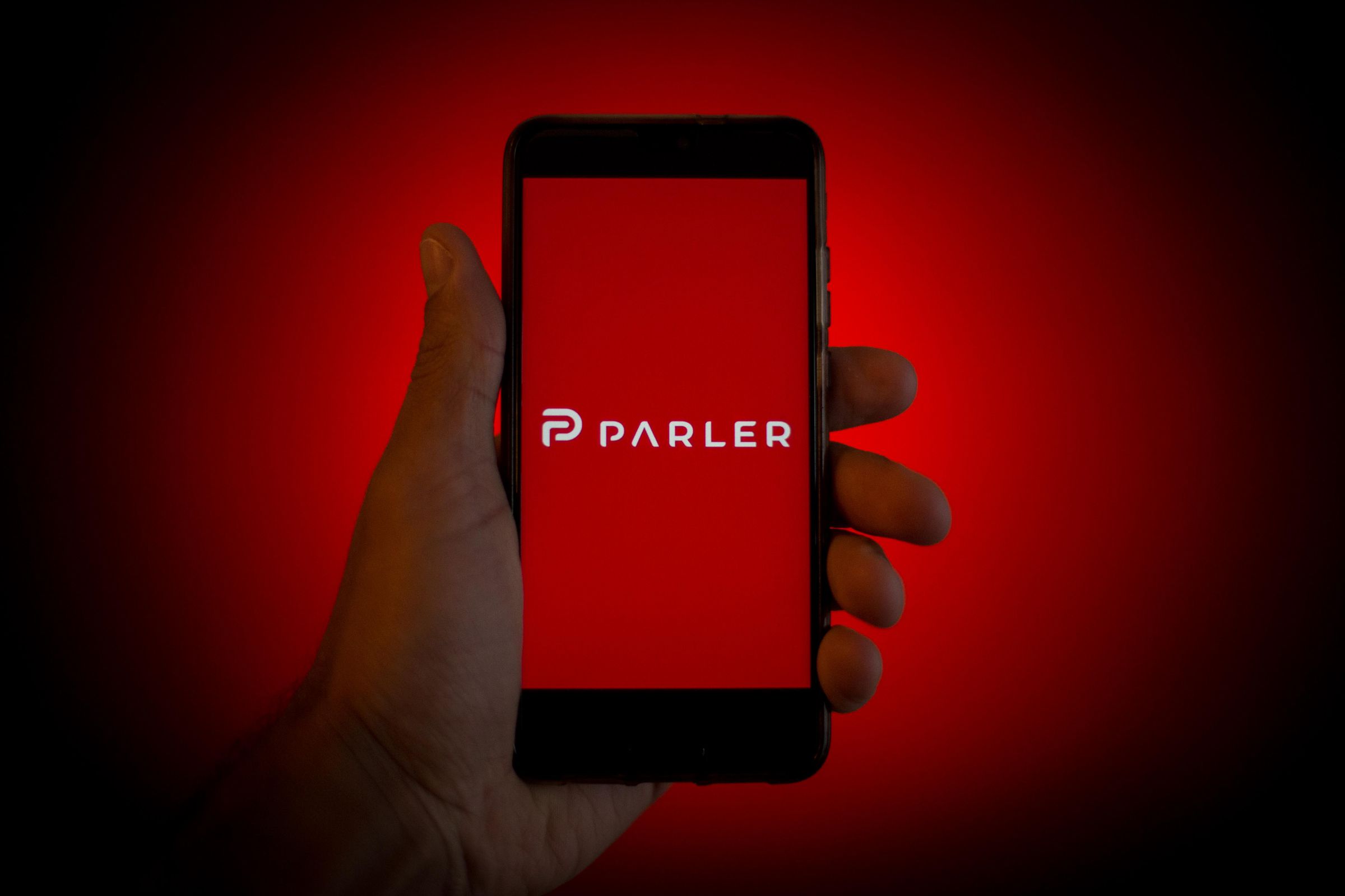 In this photo illustration a Parler logo is seen displayed...