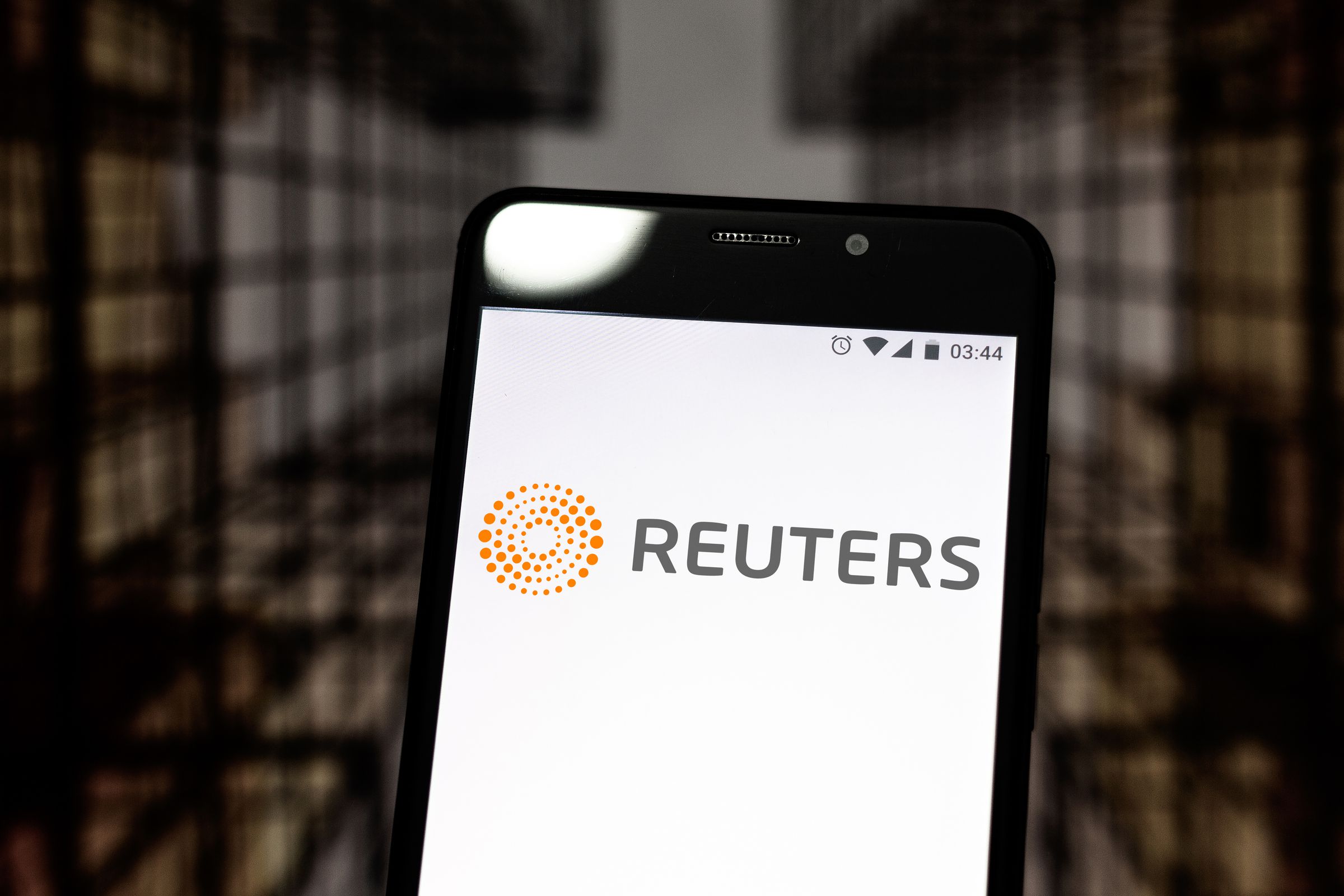 In this photo illustration a Reuters logo seen displayed on...
