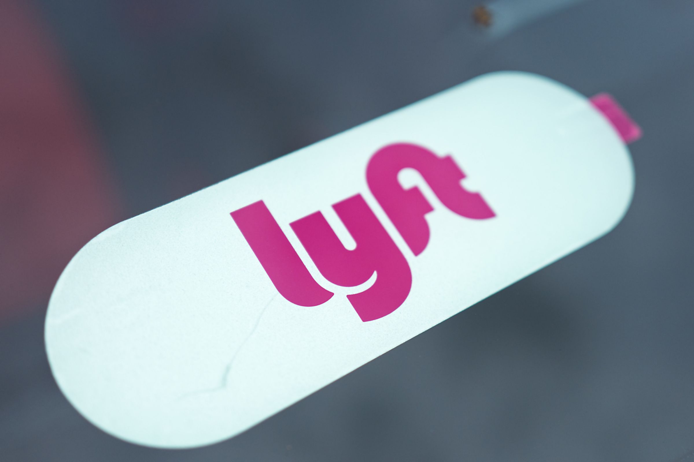 An image showing a Lyft sticker on a windshield