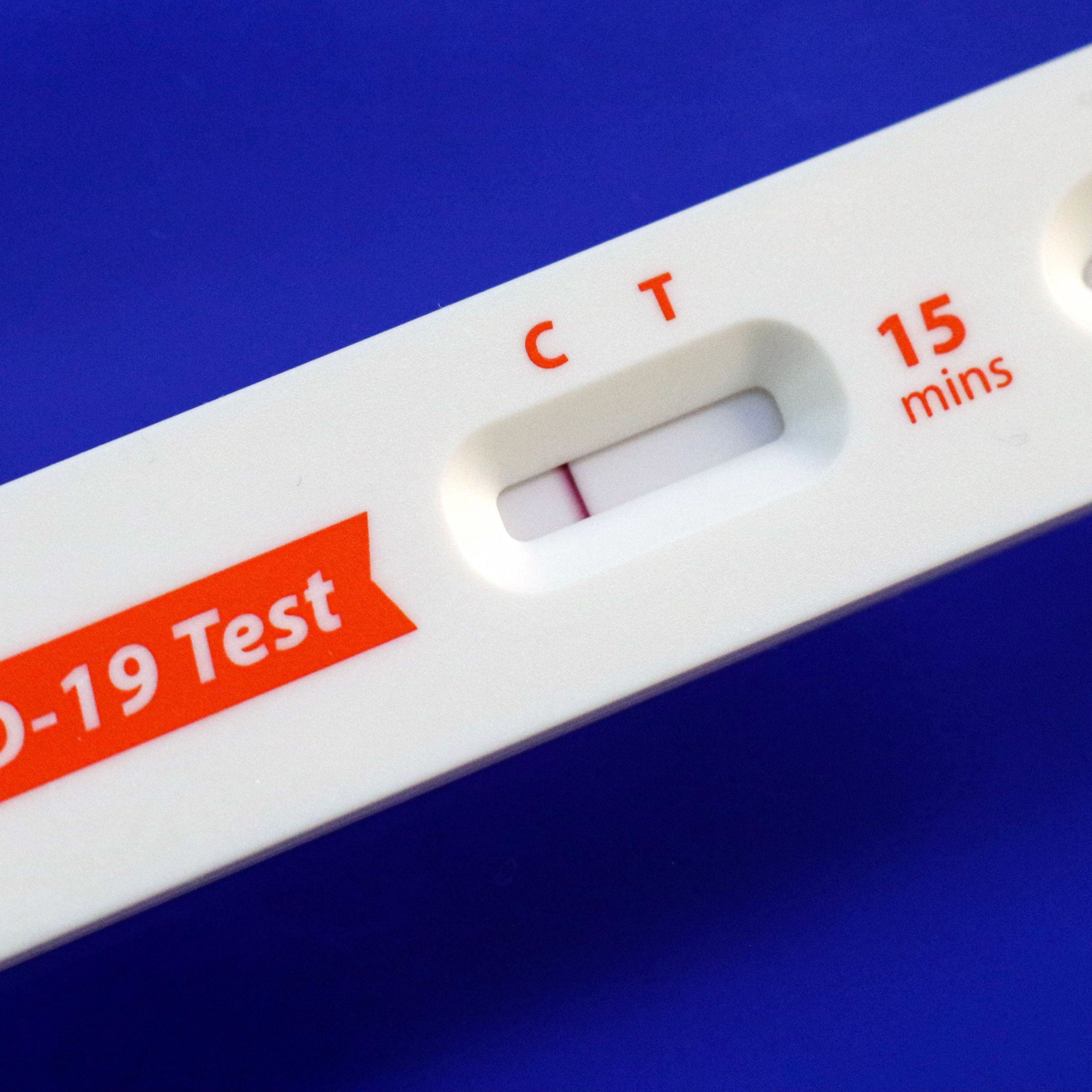 In this photo illustration, a covid-19 antigen home test kit...