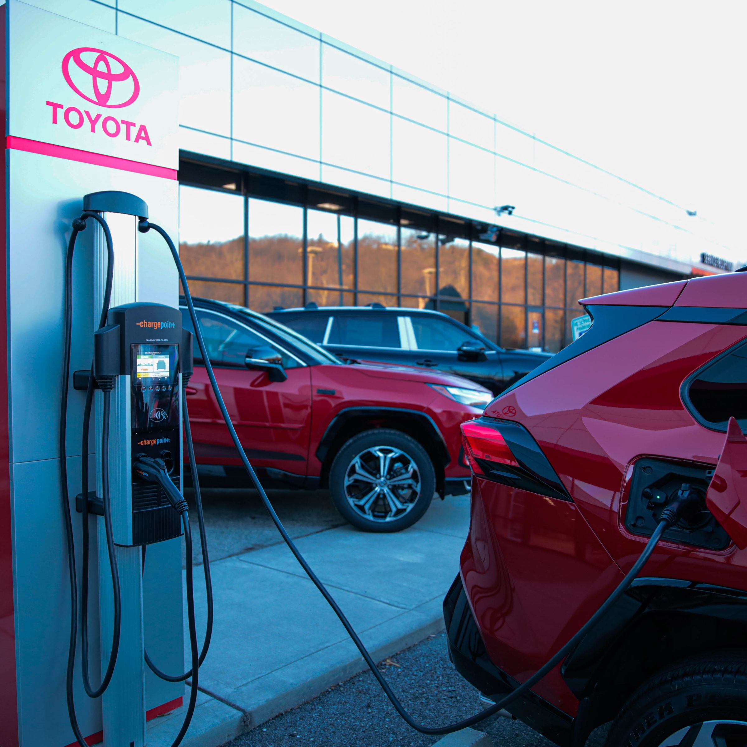 A picture of a Toyota vehicle plugged into a Toyota charging station.