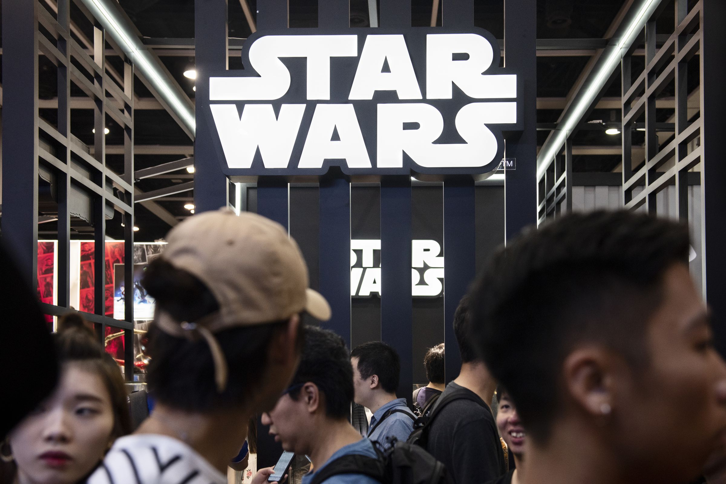 Visitors are seen at Disney’s Star Wars booth during the Ani...