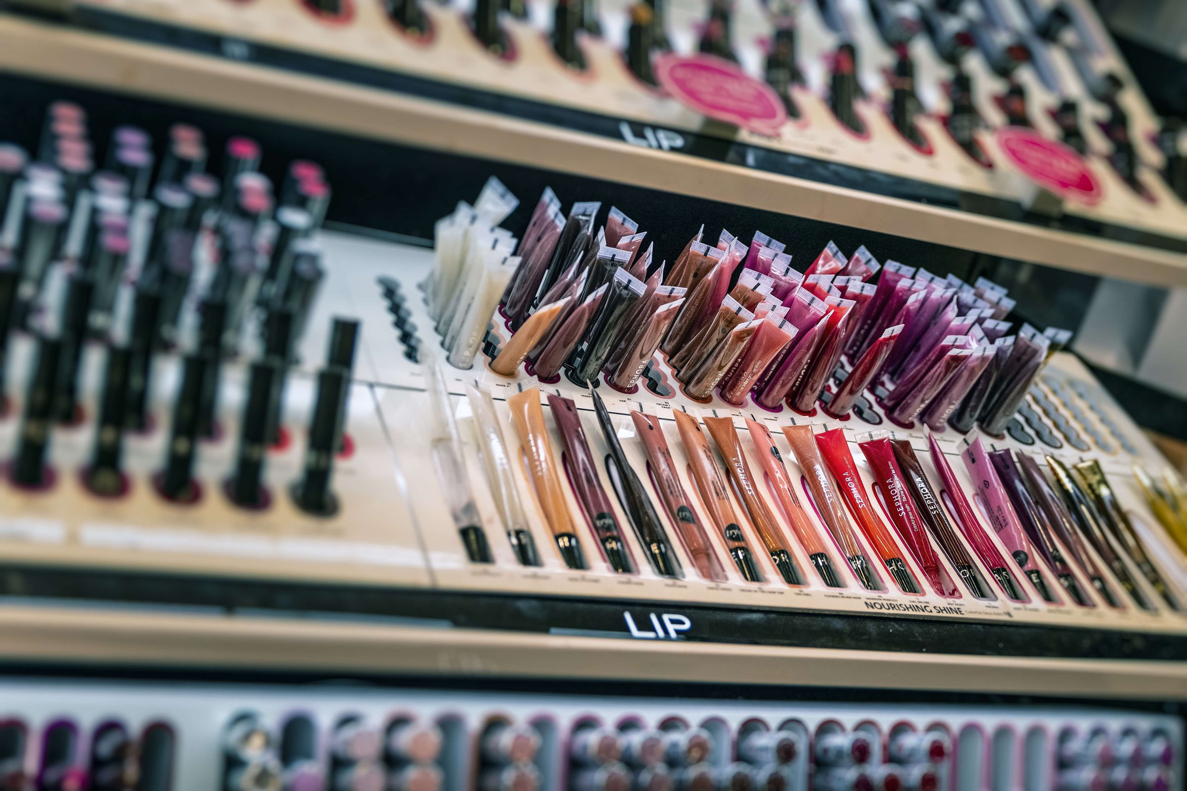 Lip gloss display in a Sephora personal care and beauty...