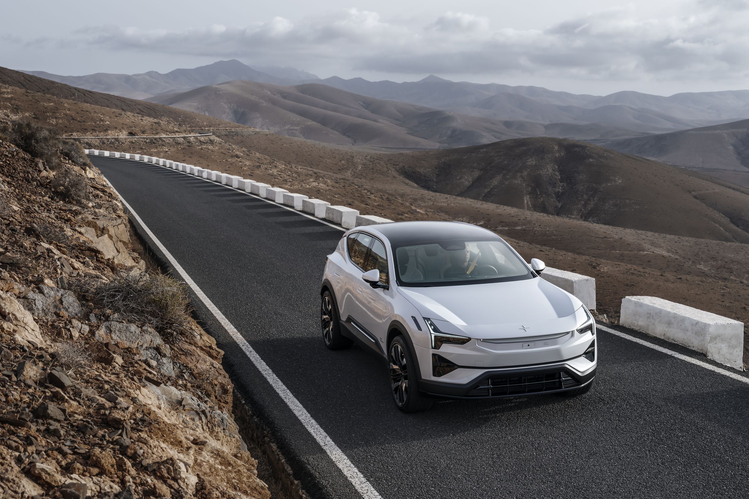 The Polestar 3 electric SUV driving down a mountain road