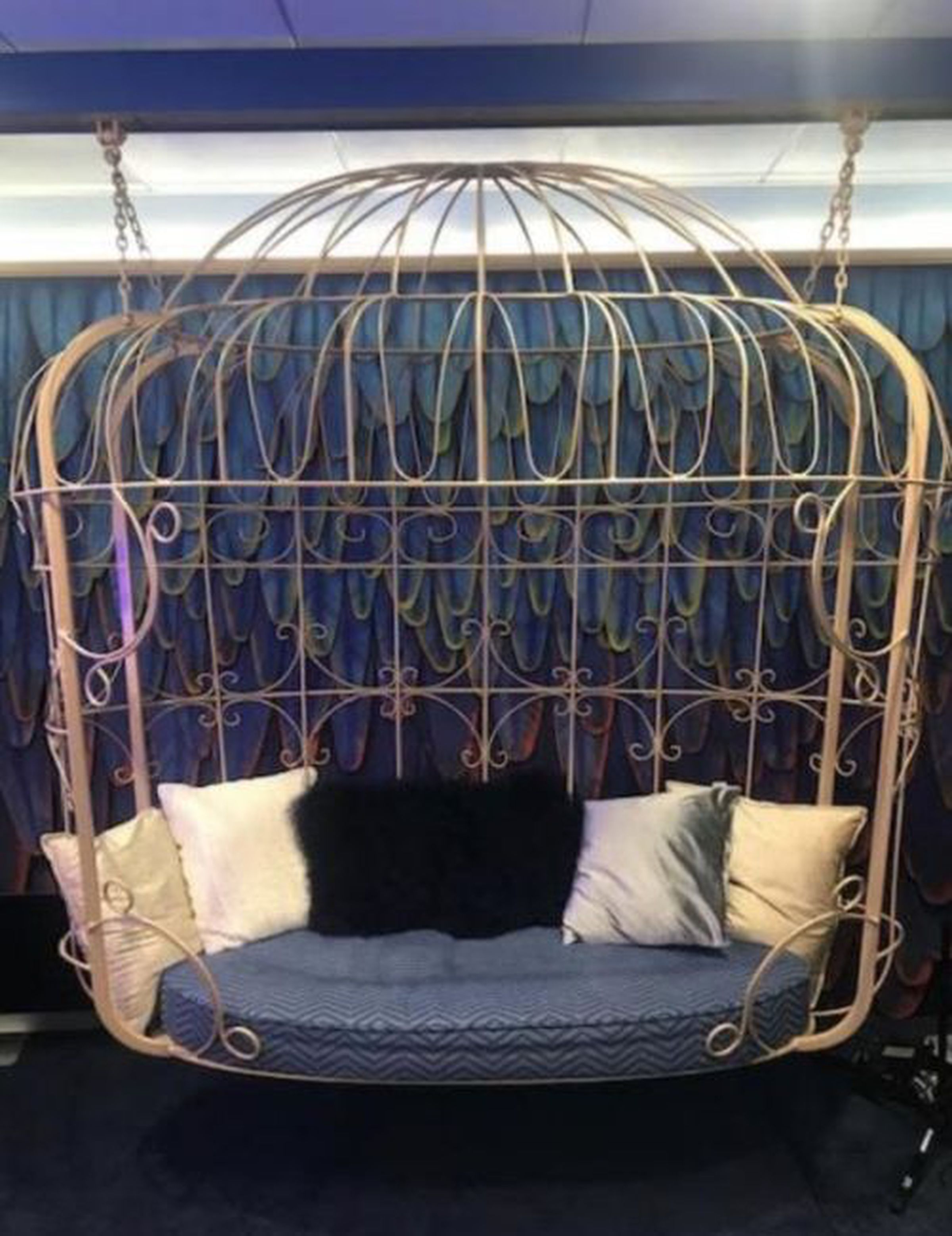An image of a listing from X’s Twitter rebranding auction showing a birdcage-shaped sofa swing.