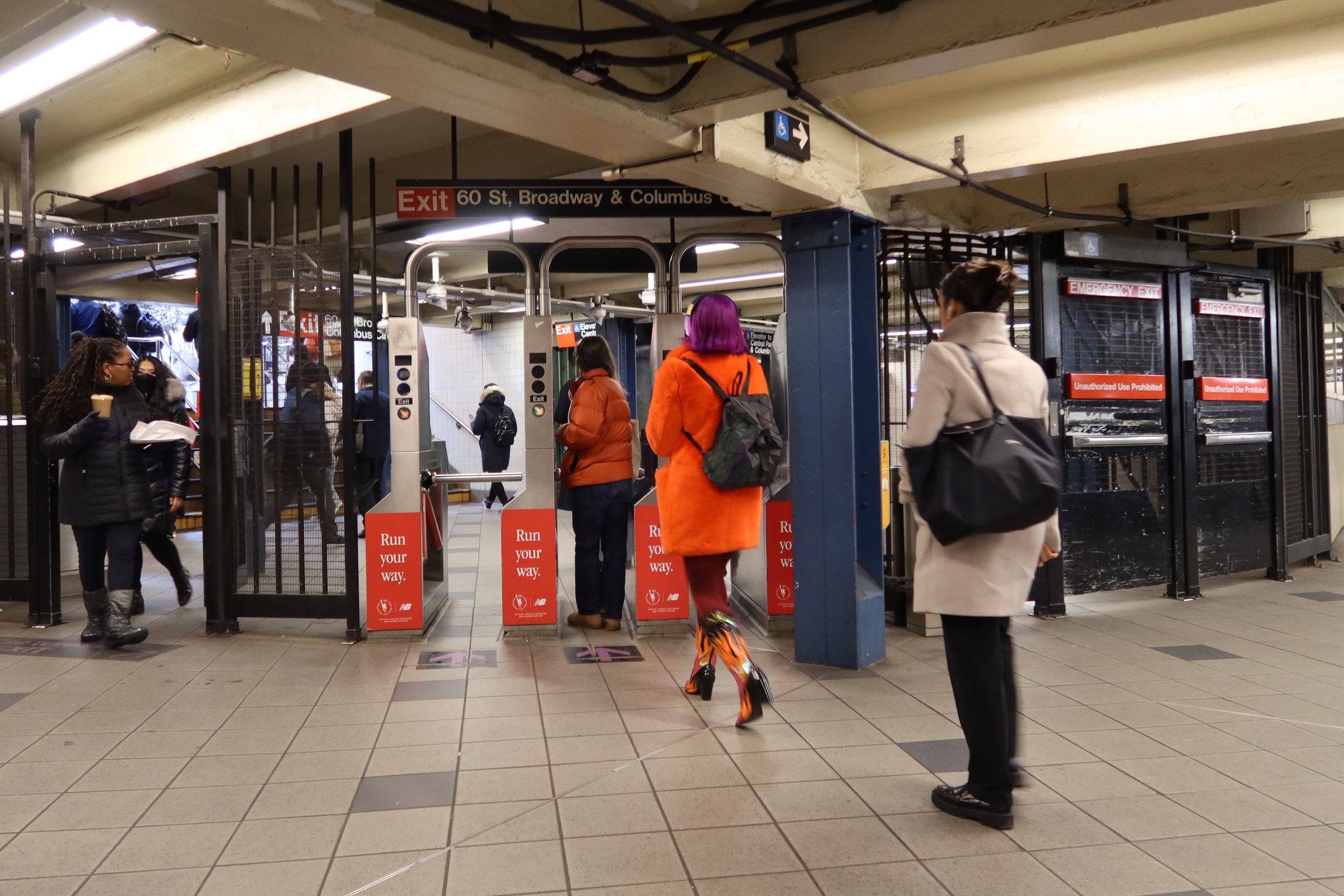 Commuters depart through a turnstile at the Columbus Circle subway station on January 11, 2023, in New York City.