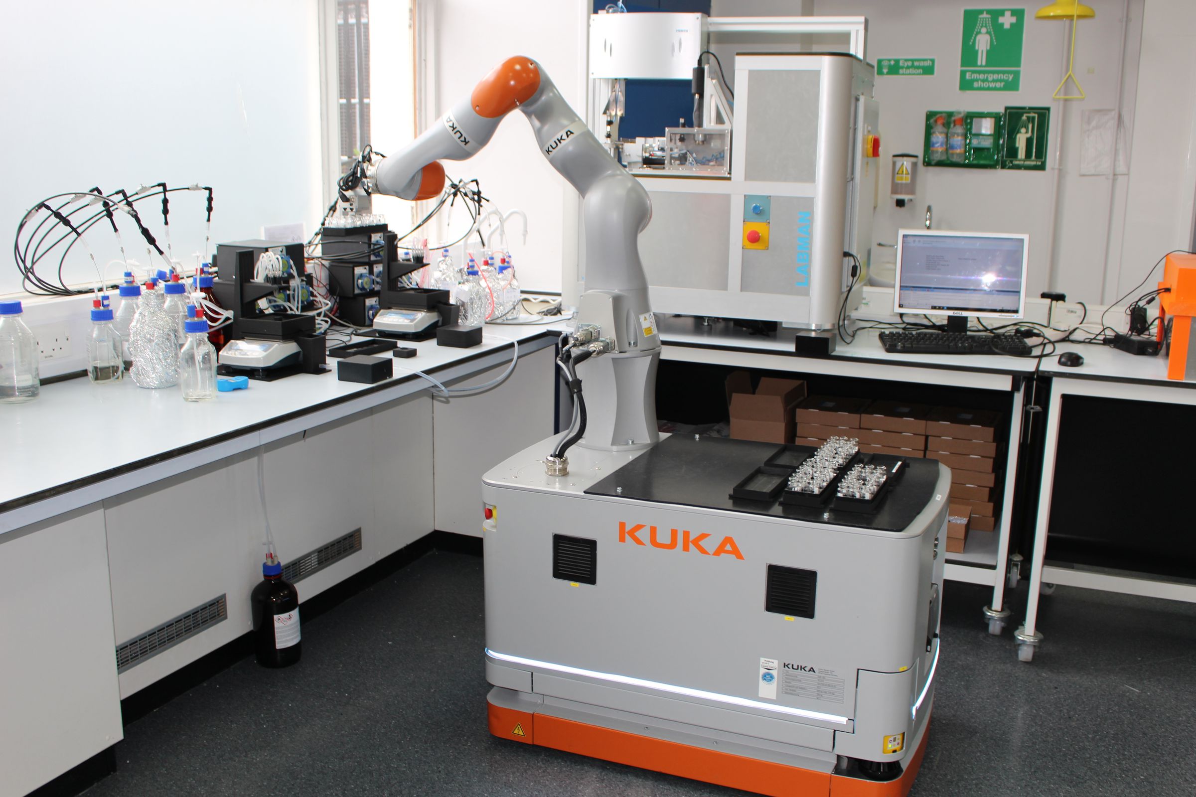 The machine uses an industrial robotic arm to manipulate equipment made for humans. 