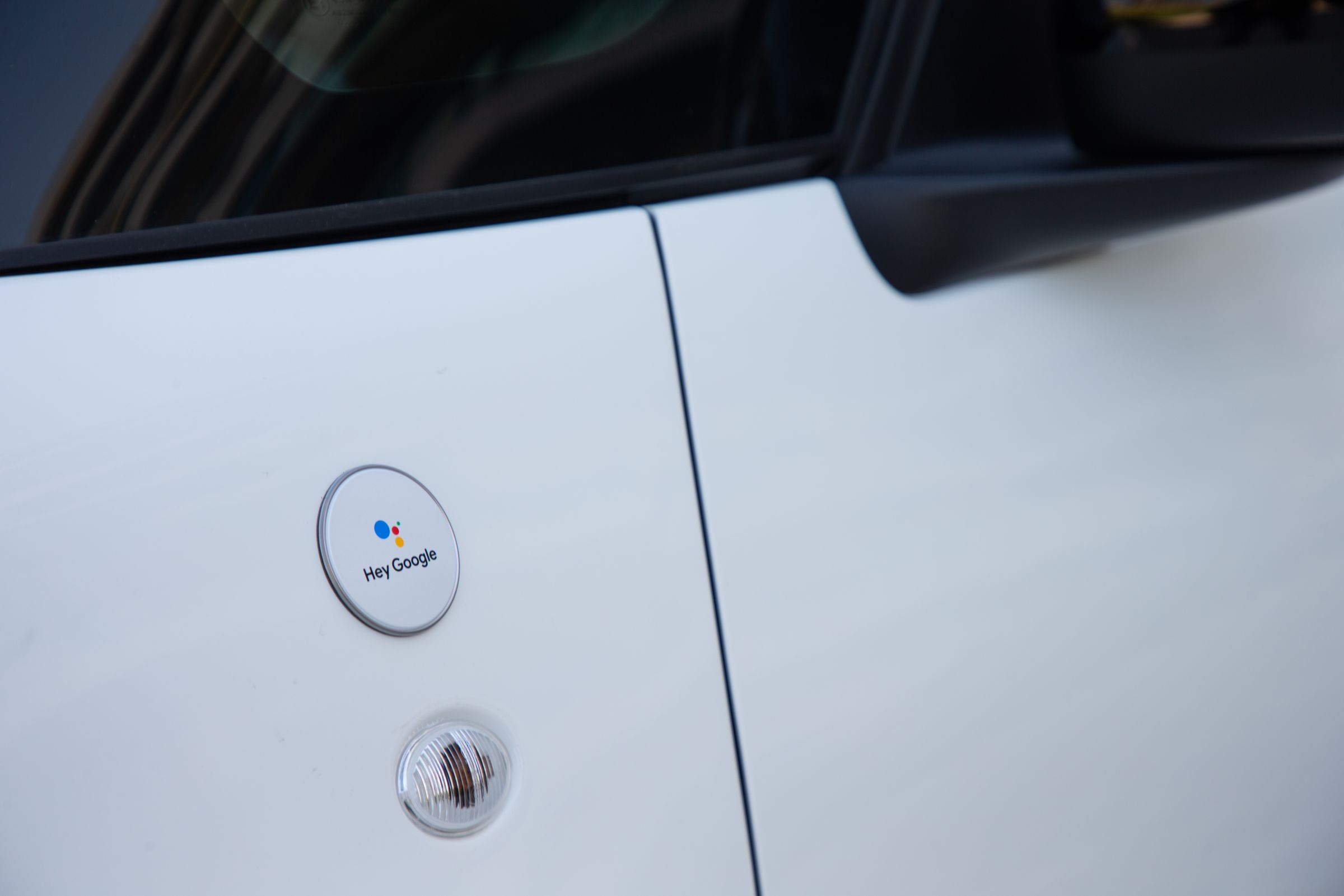 A close-up of the Hey Google logo that appears above the front wheel arches. 
