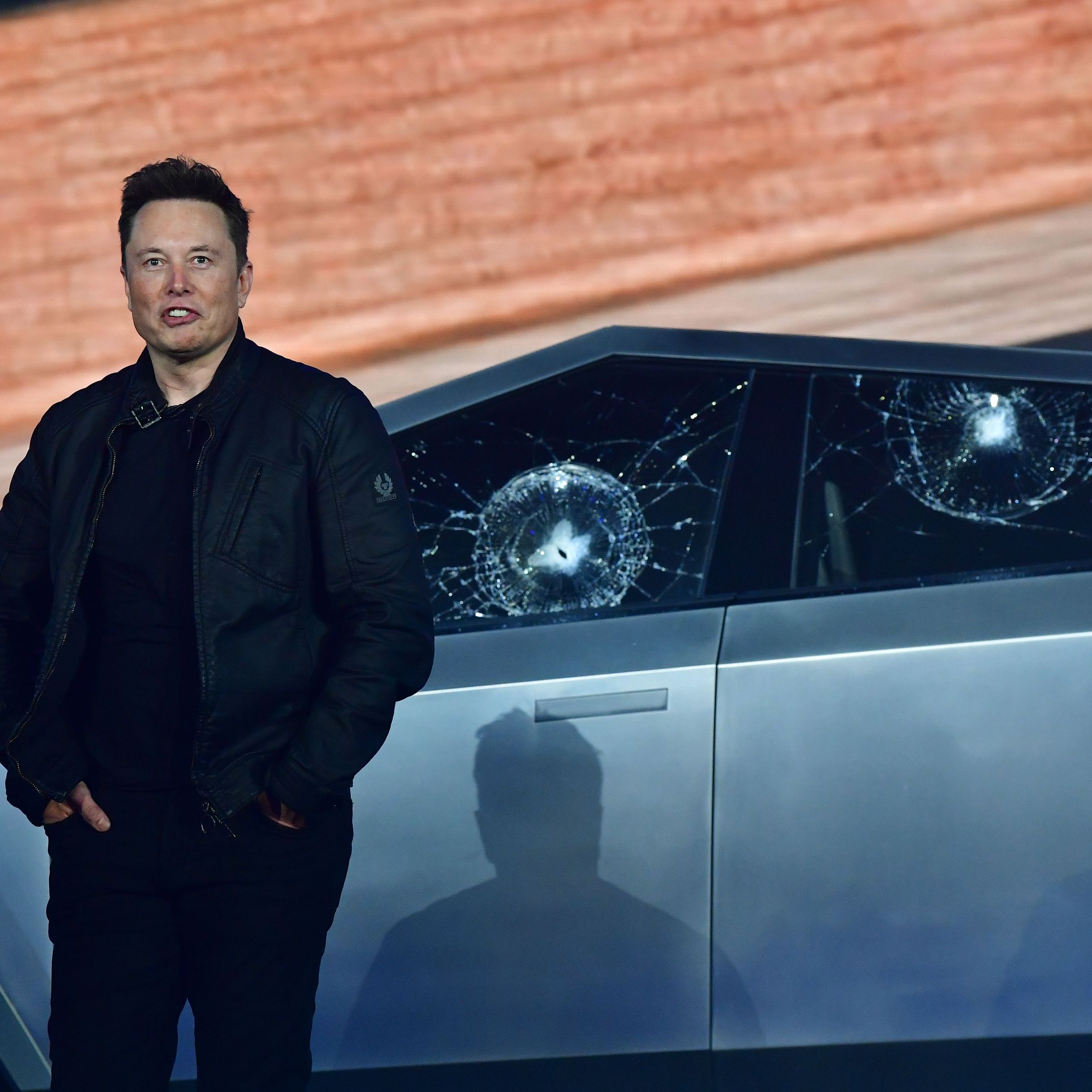Elon Musk in front of a damaged Cybertruck