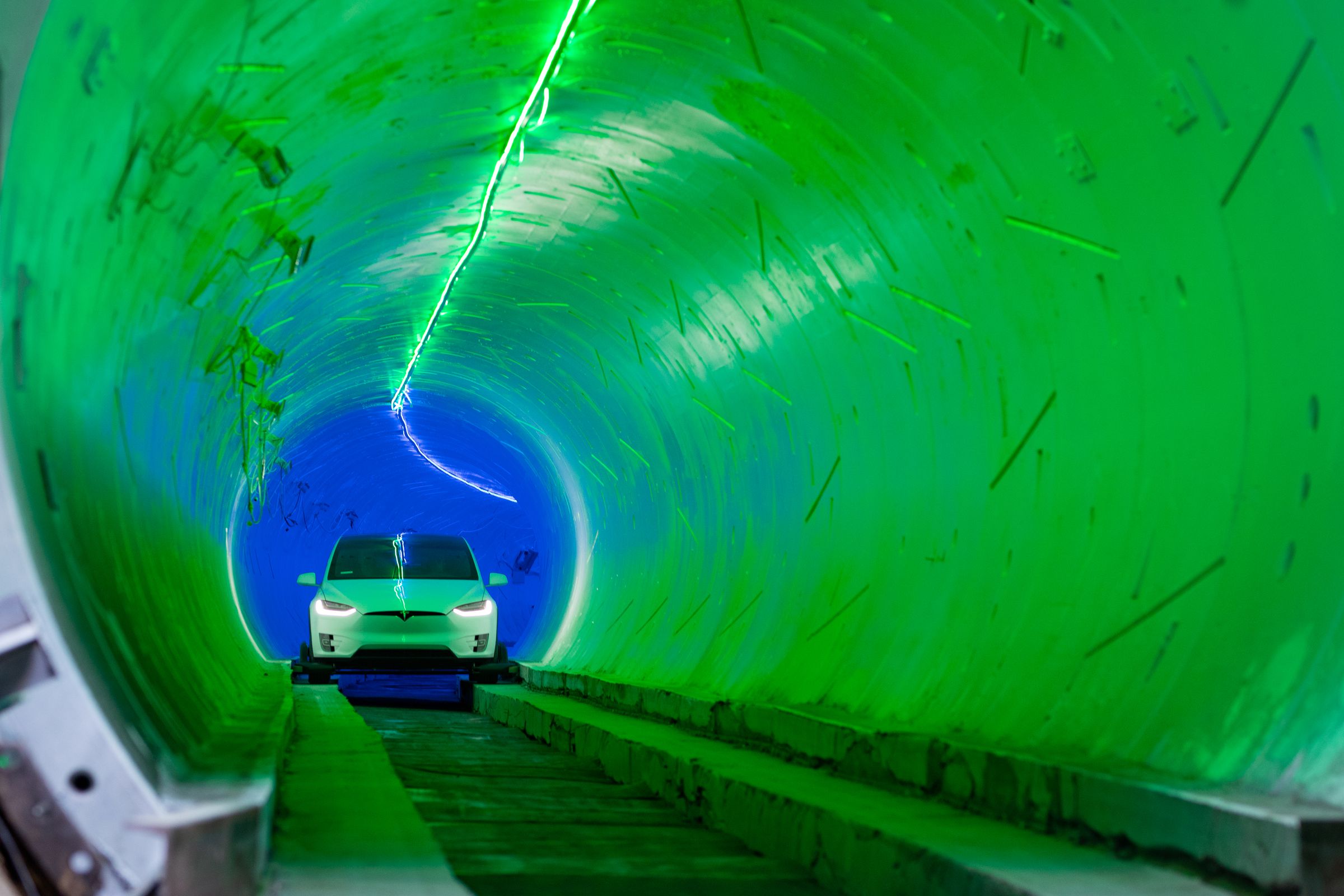 Beyond the green lights at the tunnel entrance, the blue lights of the tunnel midsection appear