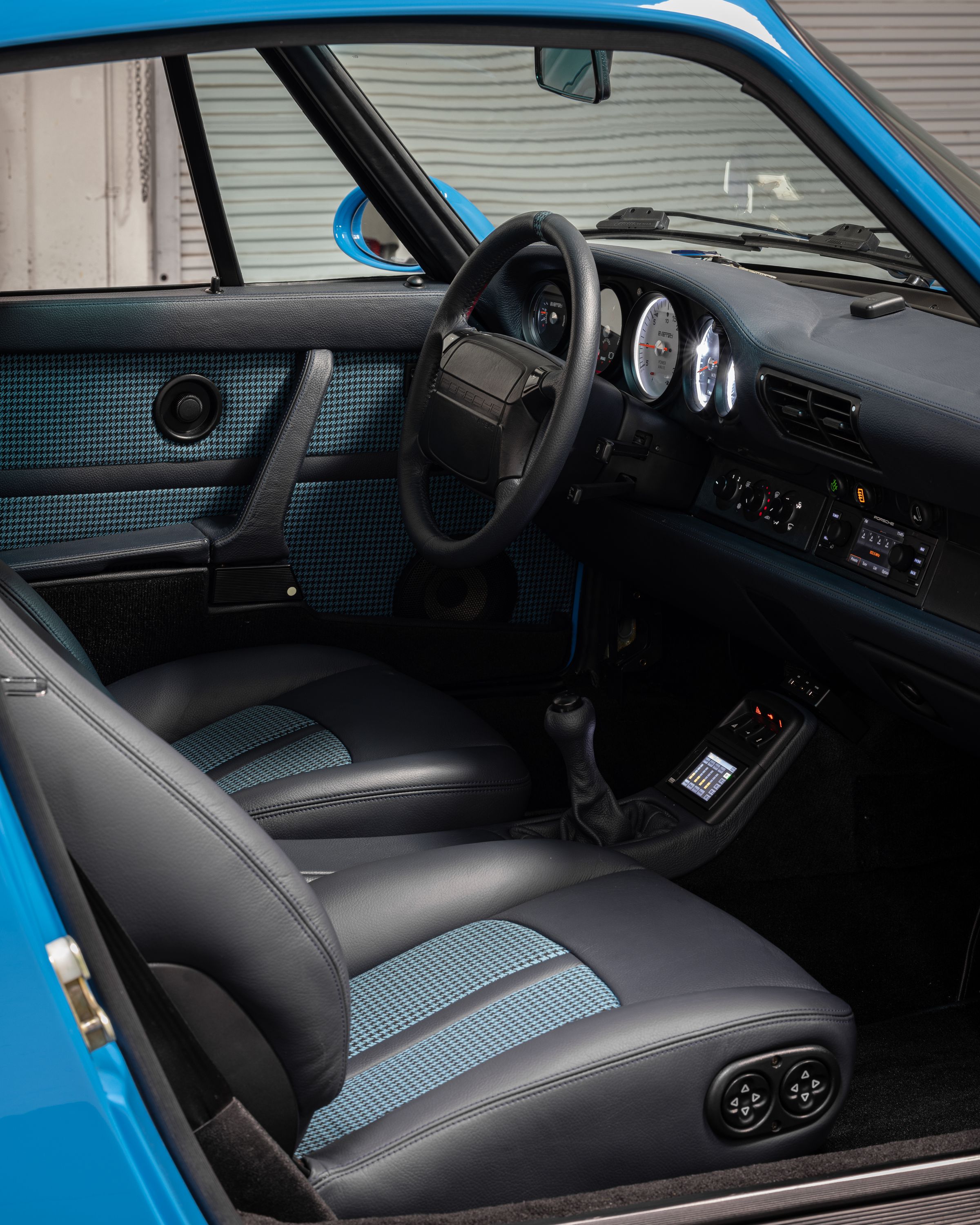 Matt Roger’s Everrati Porsche 911 has fresh leather upholstery, but mostly original console parts.