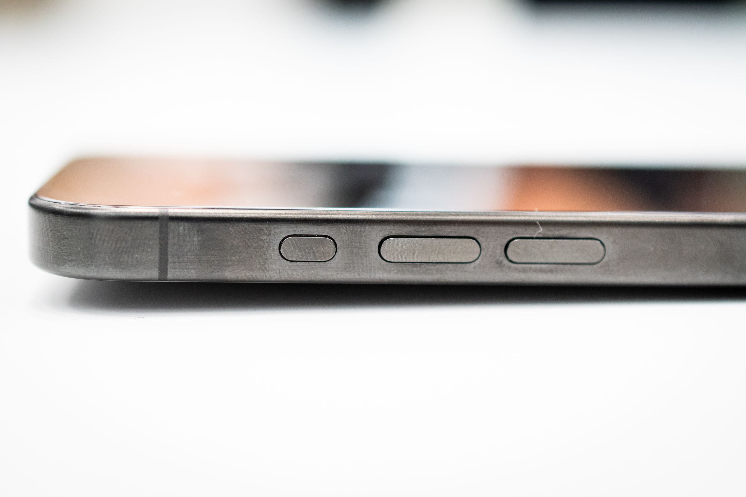 iPhone 15 Pro showing fingerprints on black titanium
