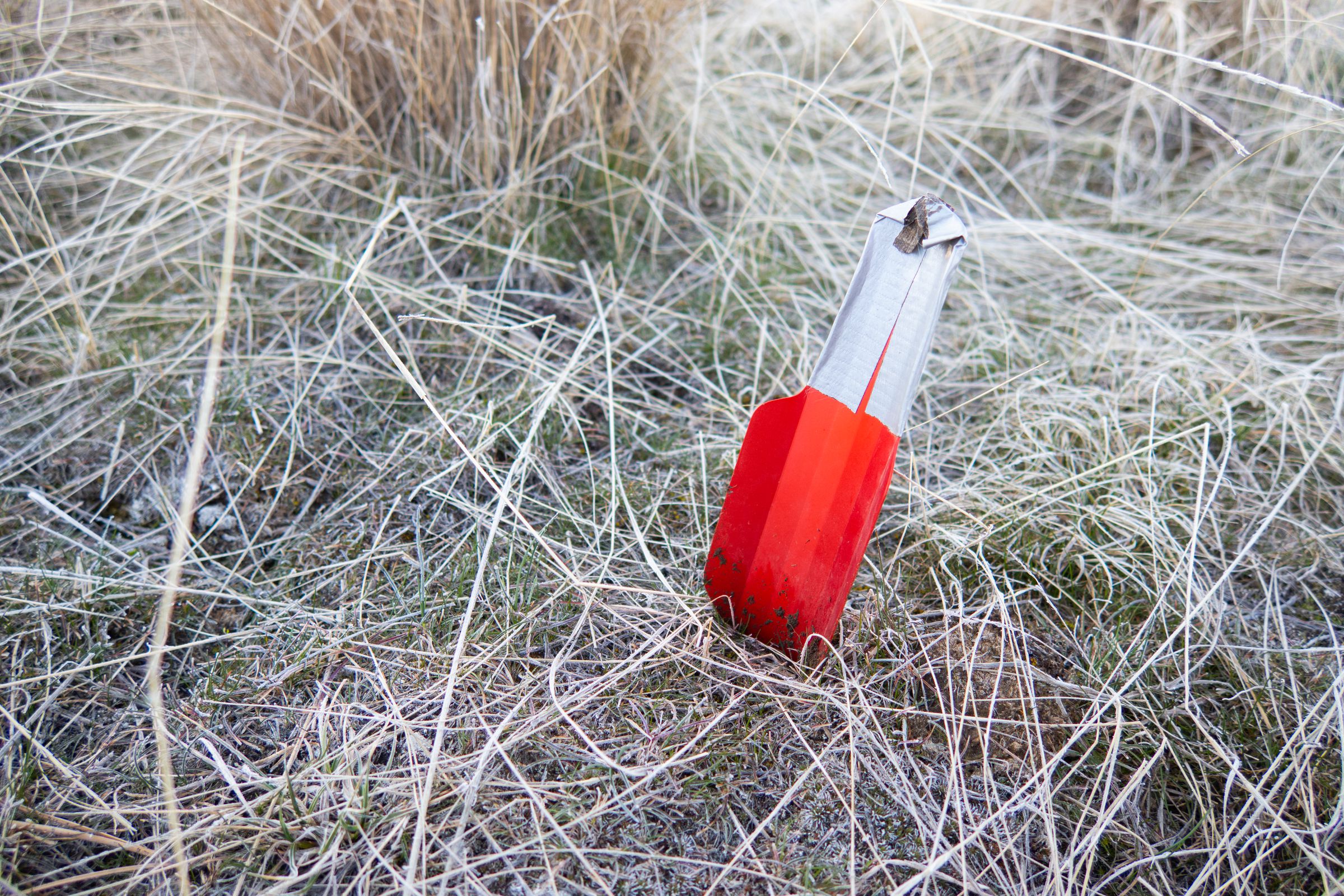 Photo of an ultralight trowel stuck in the ground.