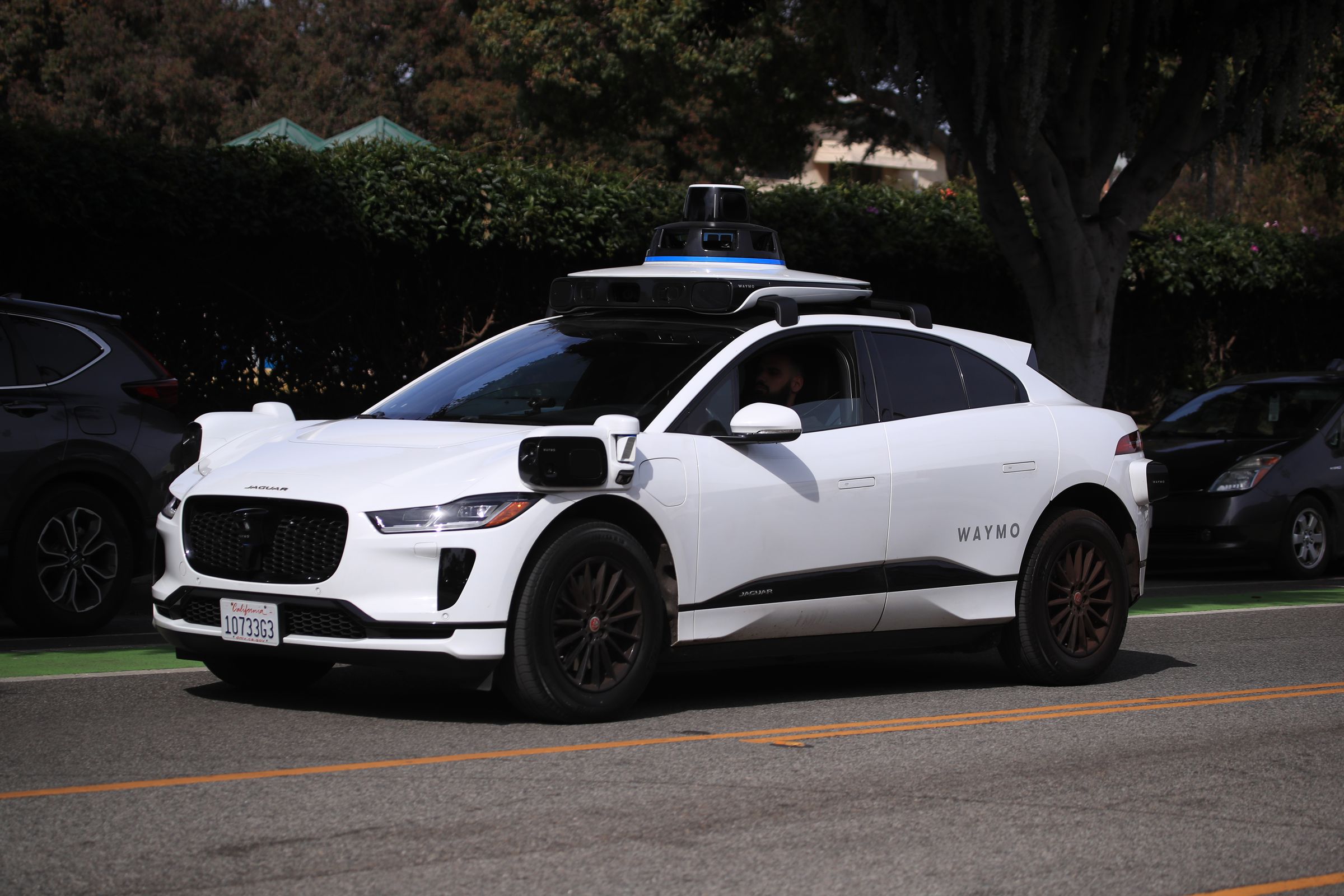 A self-driving Waymo car drives on a road in Santa Monica on February 21st, 2023.