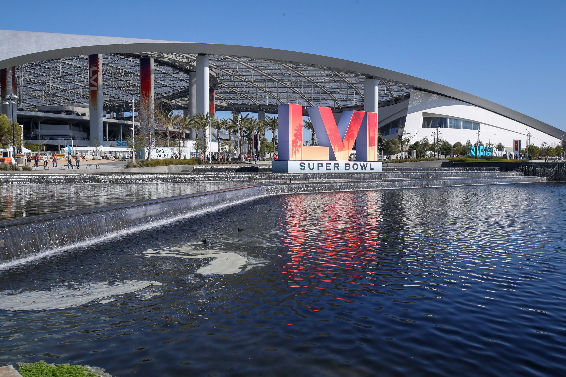 An outside shot of SoFi Stadium in Los Angeles ahead of Super Bowl LVI, featuring the logo for the Super Bowl spelled out in roman numerals.