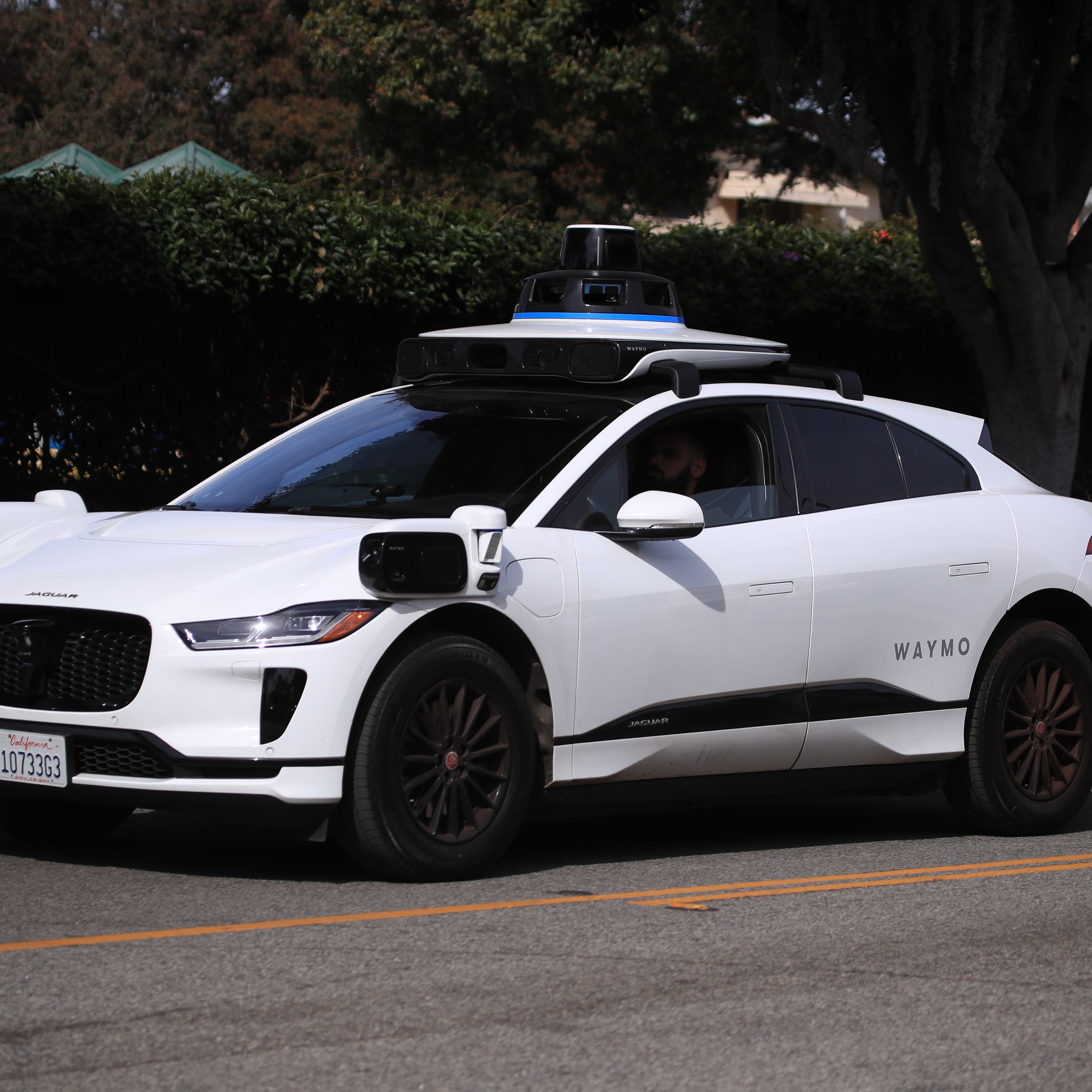 A self-driving Waymo car drives on a road in Santa Monica on February 21st, 2023.