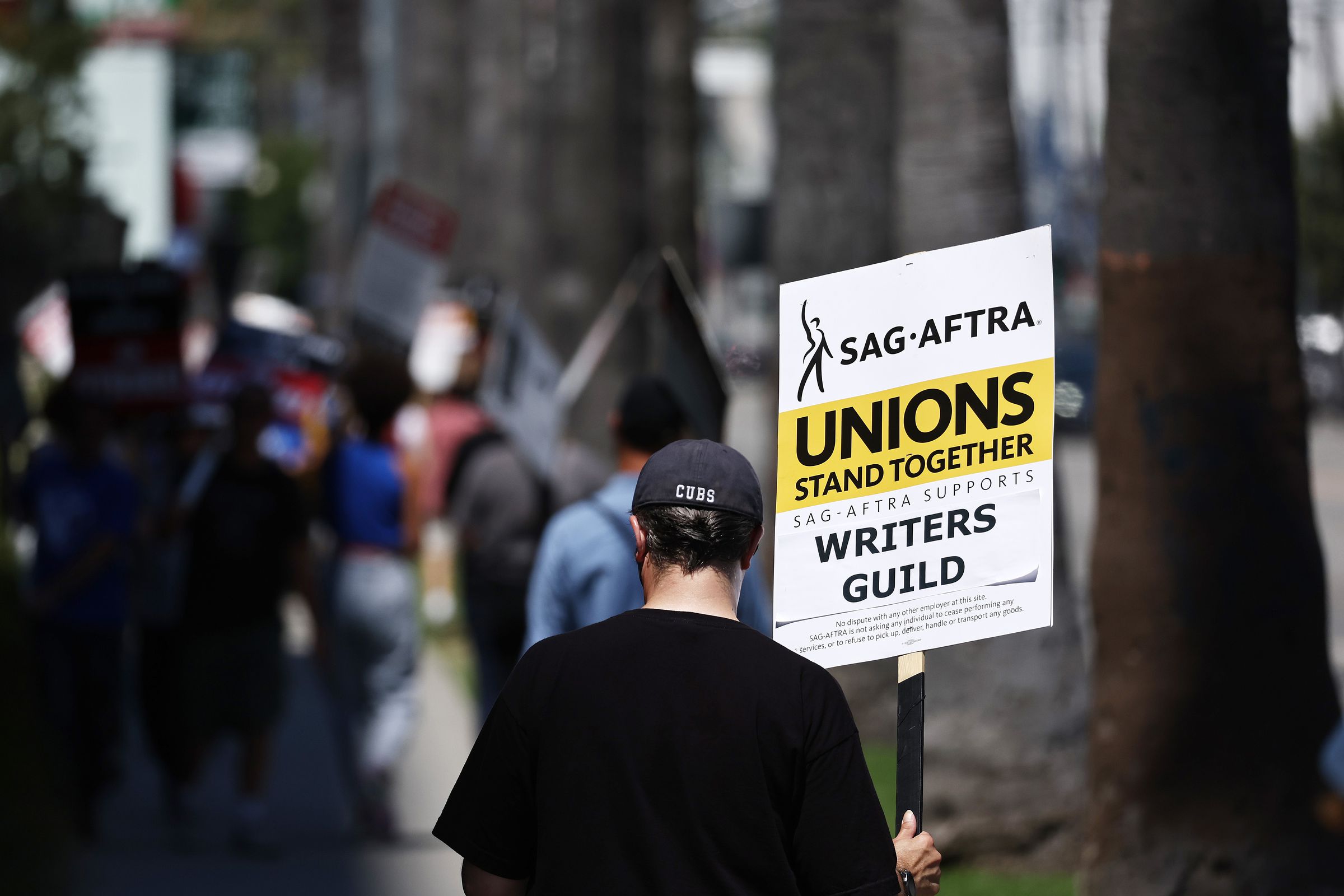 A sign reads ‘Unions Stand Together’ as SAG-AFTRA members walk the picket line in solidarity with striking WGA (Writers Guild of America) workers.