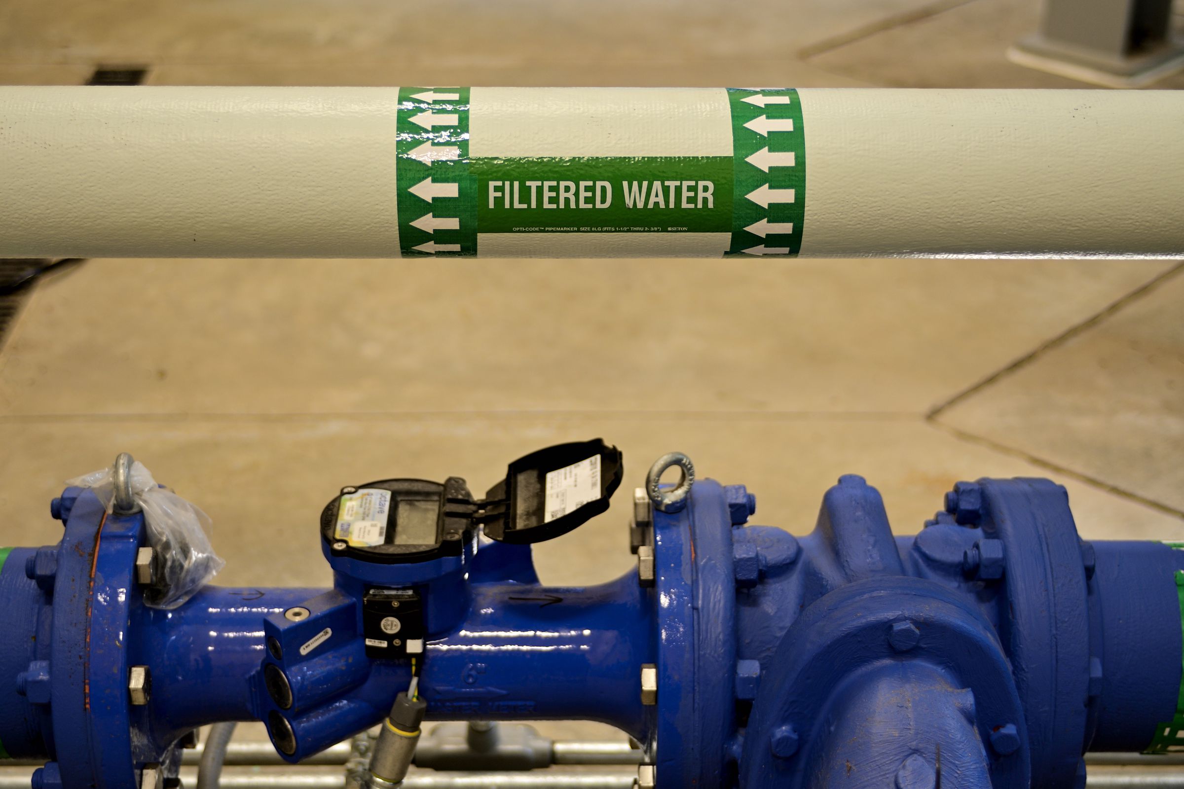 Pipes for a filtration system, with a label that says “filtered water.”