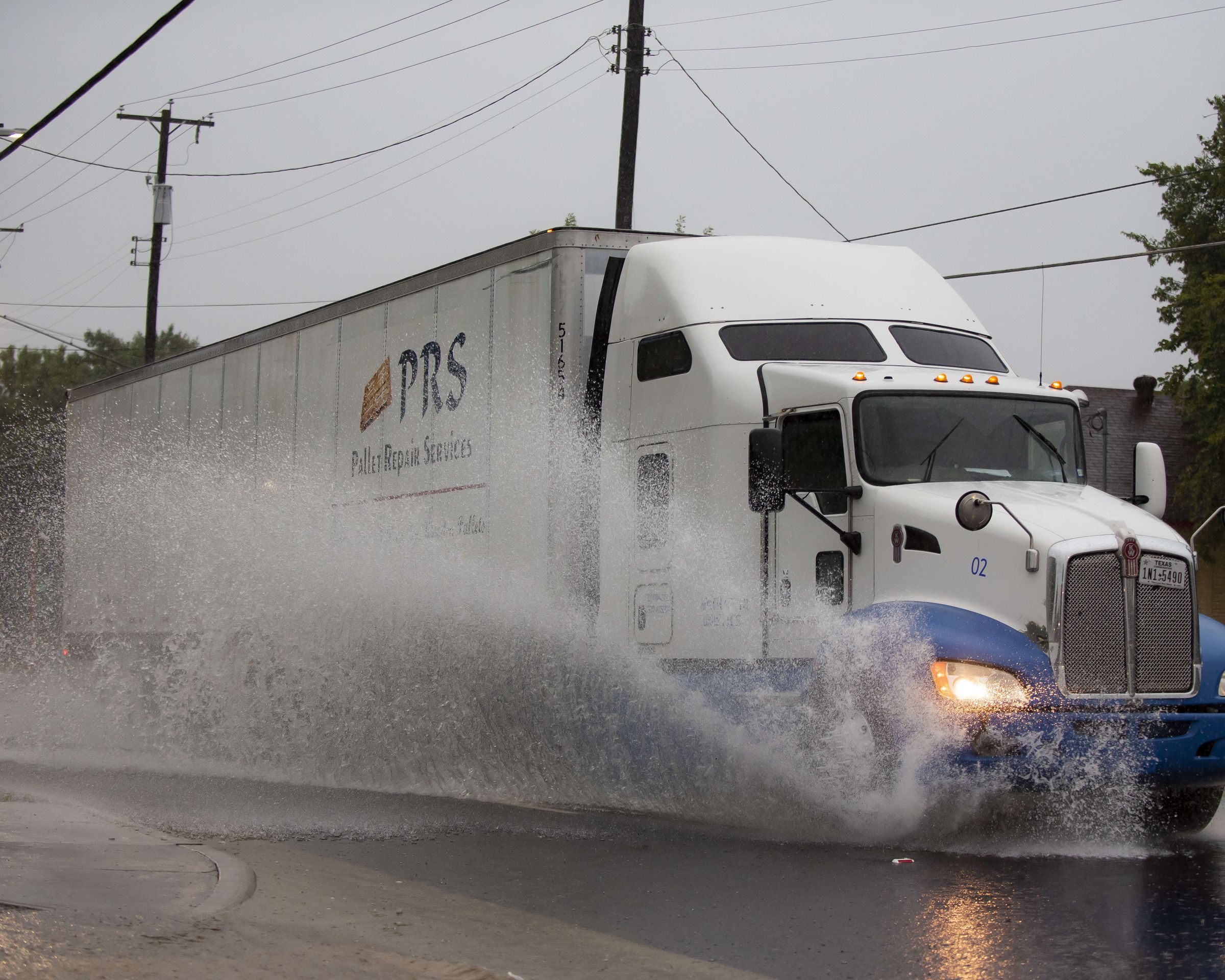 DALLAS, TX - AUGUST 22: A semi-truck drives through high water