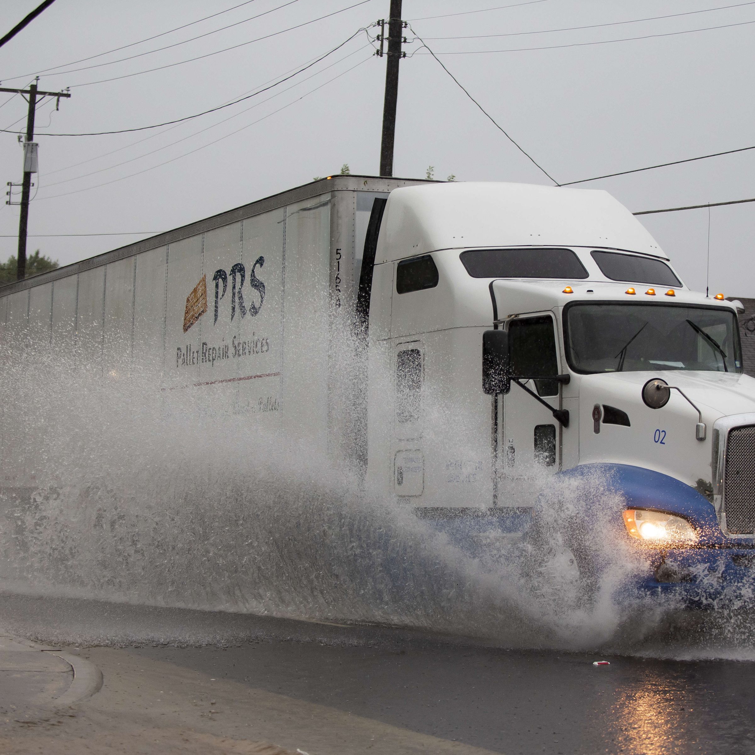 DALLAS, TX - AUGUST 22: A semi-truck drives through high water