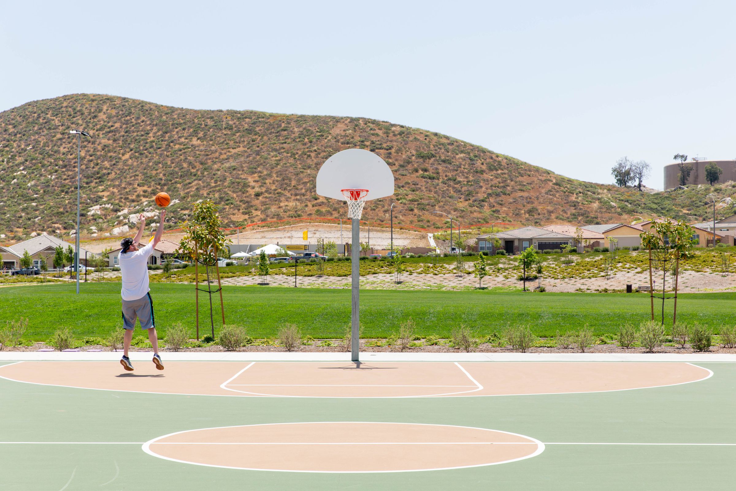 Terry Eichelberg plays basketball on Monday at the new park at KB Home’s Durango at Shadow Mountain.