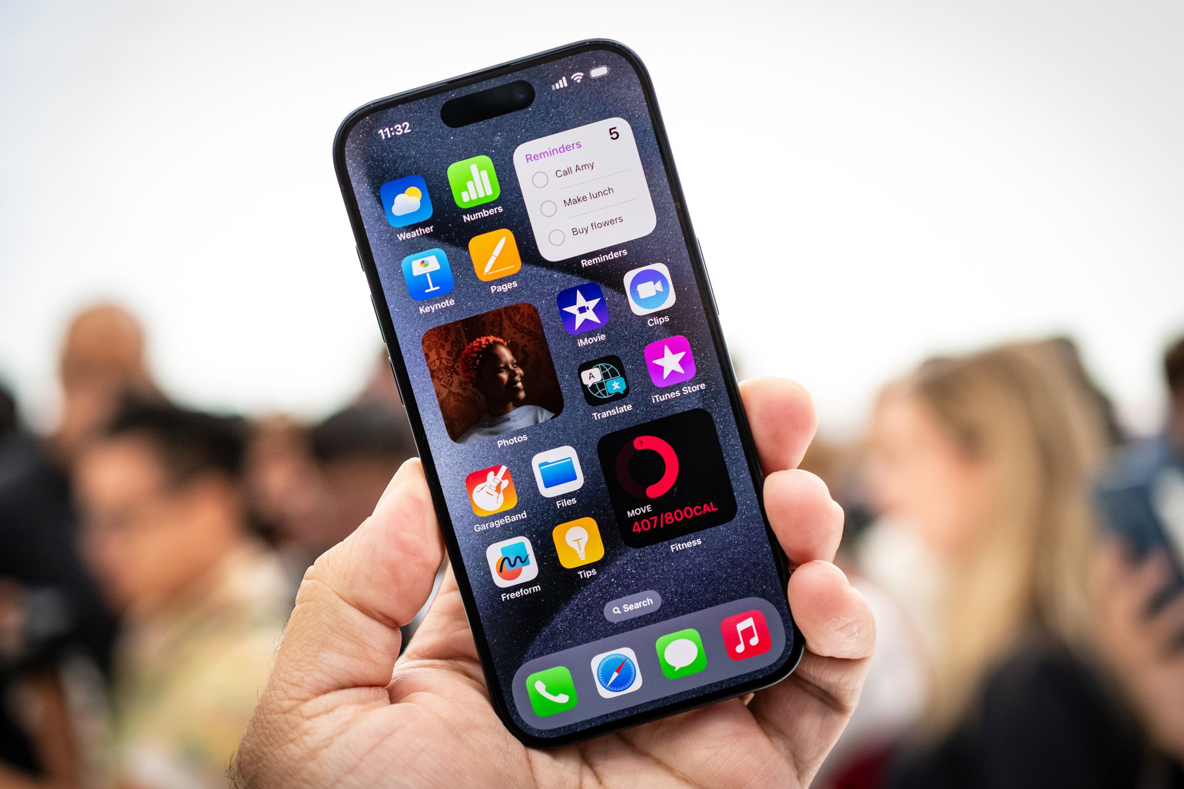 A photo showing someone holding an iPhone 15