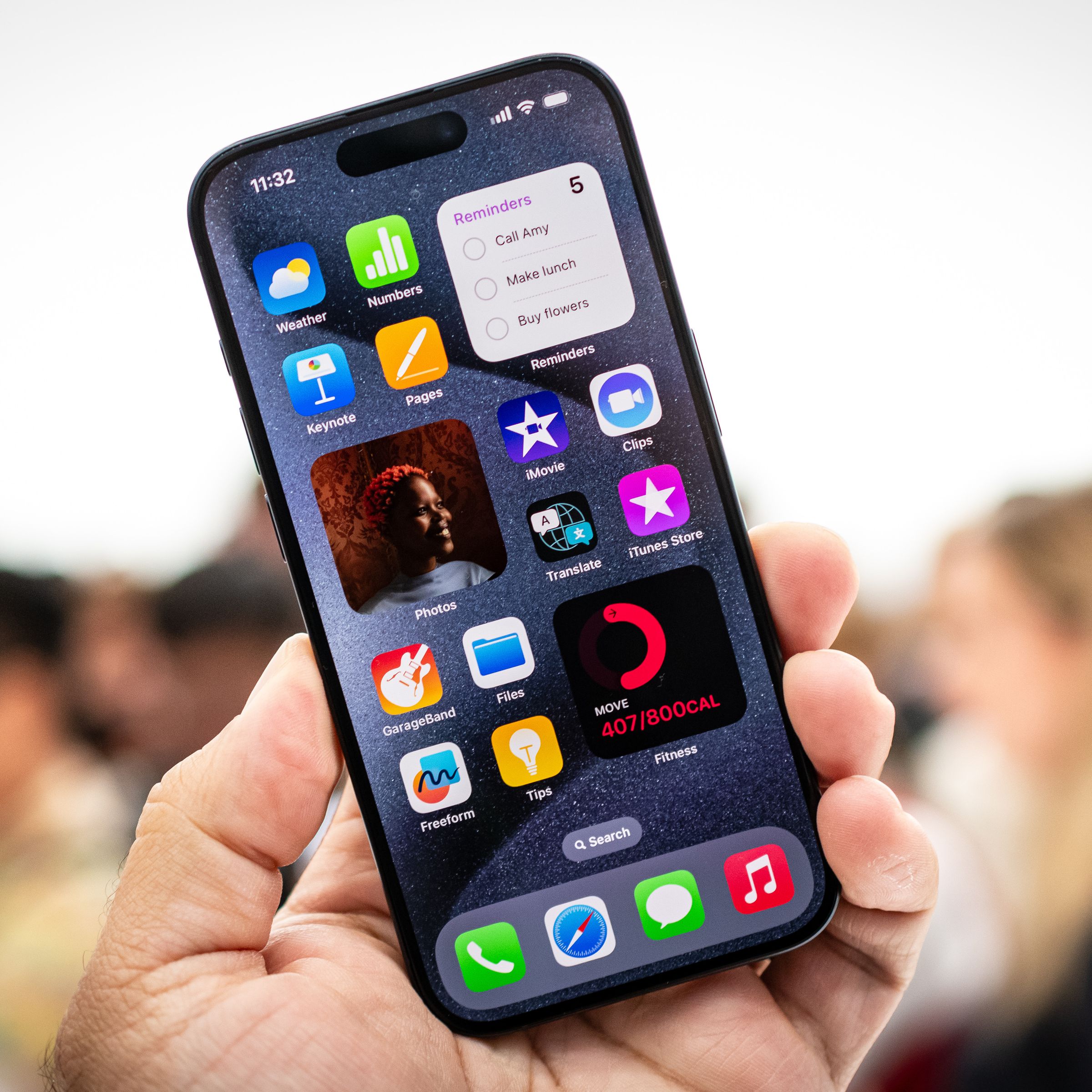 A photo showing someone holding an iPhone 15